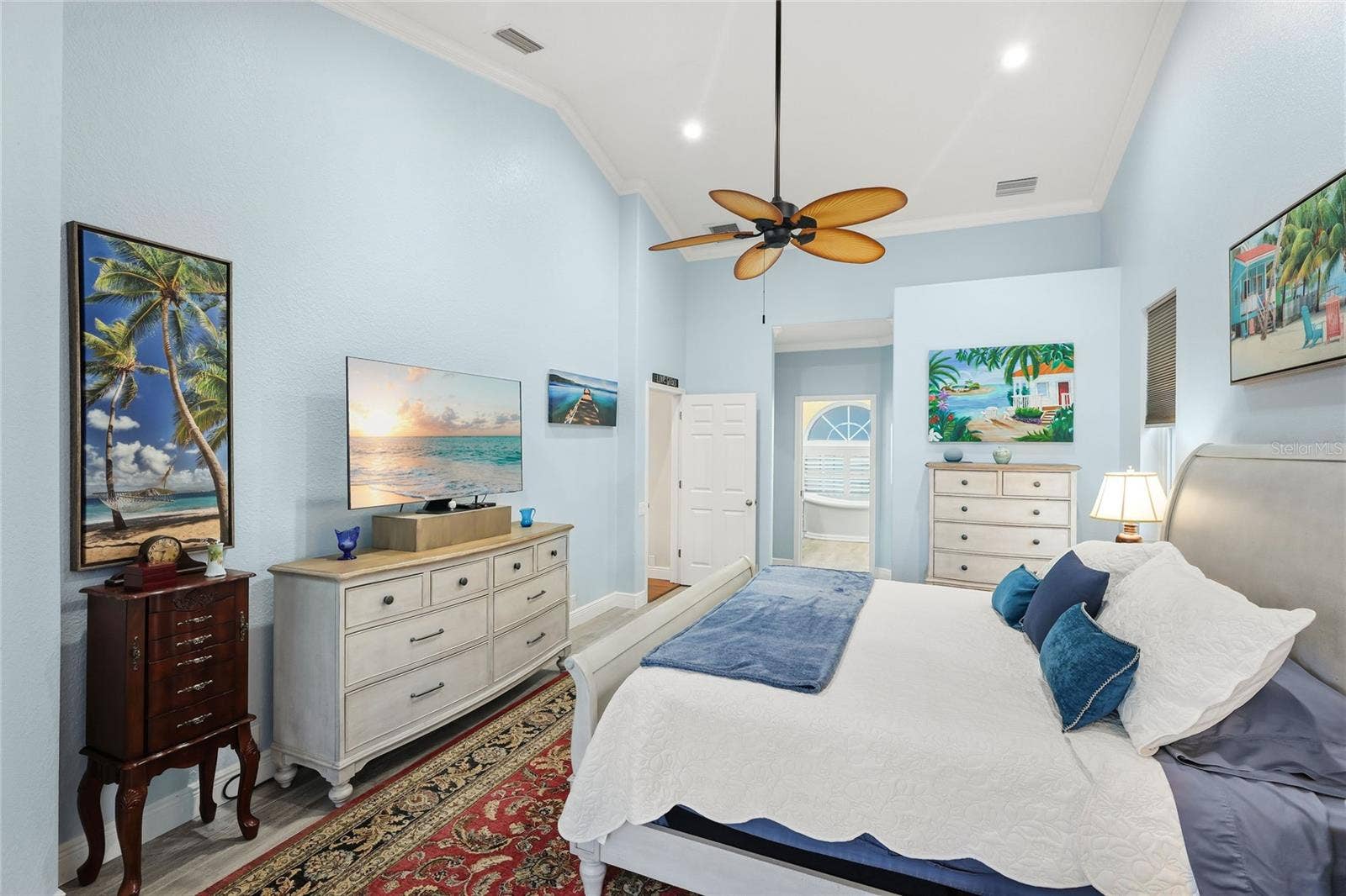 3306 LITTLE COUNTRY ROAD, Parrish, FL 34219 Primary suite with walk-in closet and renovated bathroom features six-inch crown molding throughout.