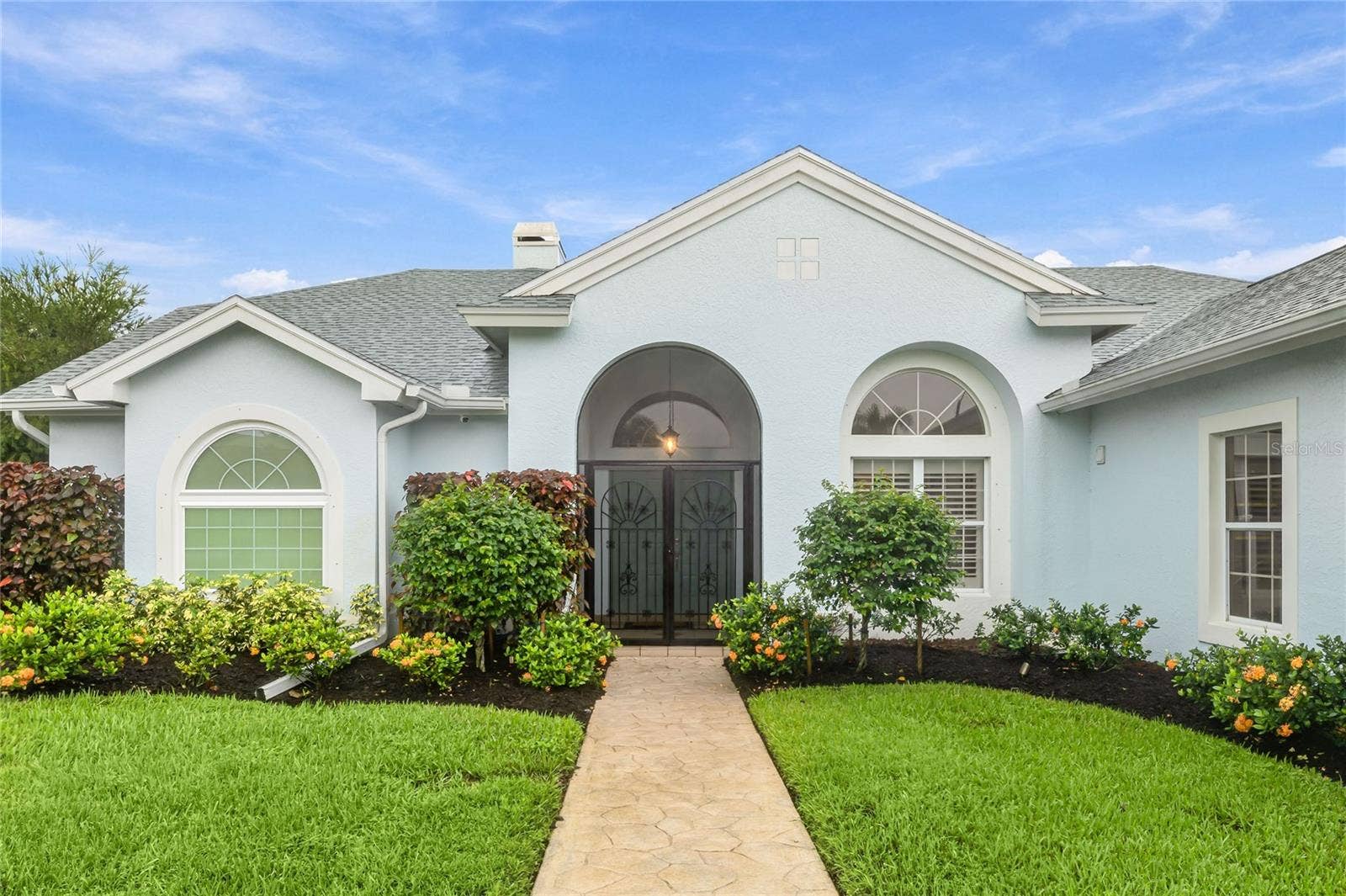 3306 LITTLE COUNTRY ROAD, Parrish, FL 34219 The front entry is highlighted by a paver walkway and wrought iron gate