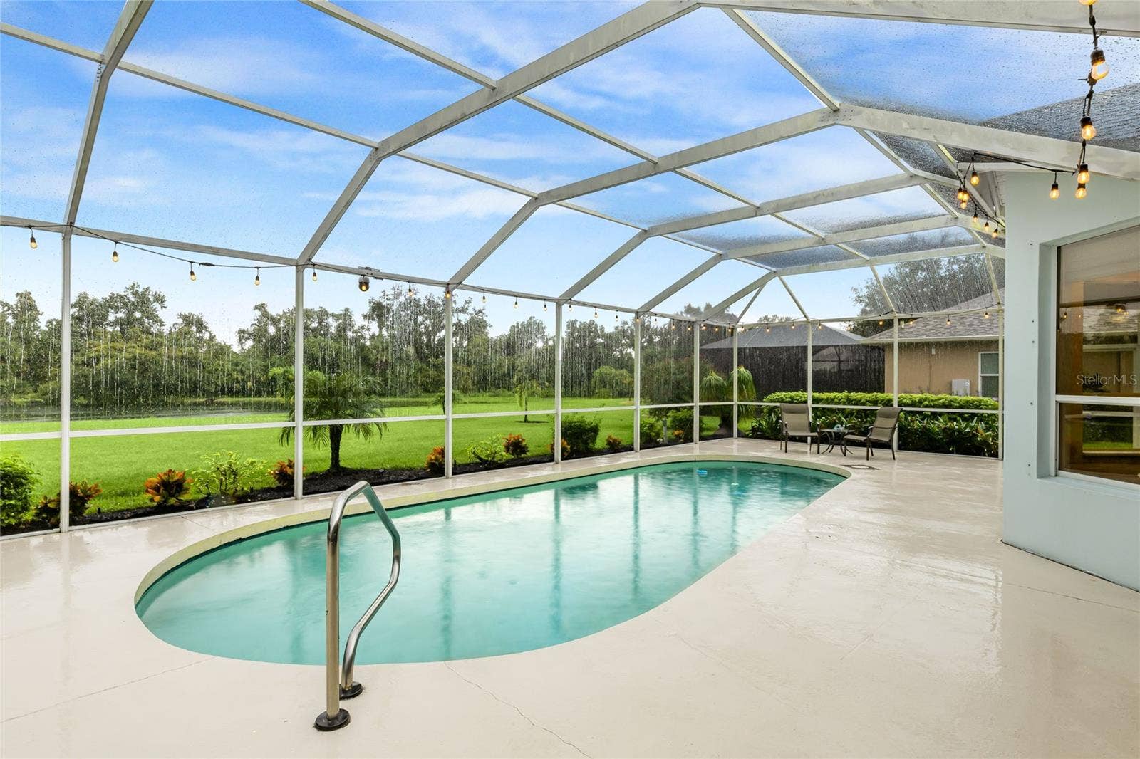 3306 LITTLE COUNTRY ROAD, Parrish, FL 34219 Private in-ground pool with a lake view, featuring a new pool pump, custom landscaping with hard-wired lighting.