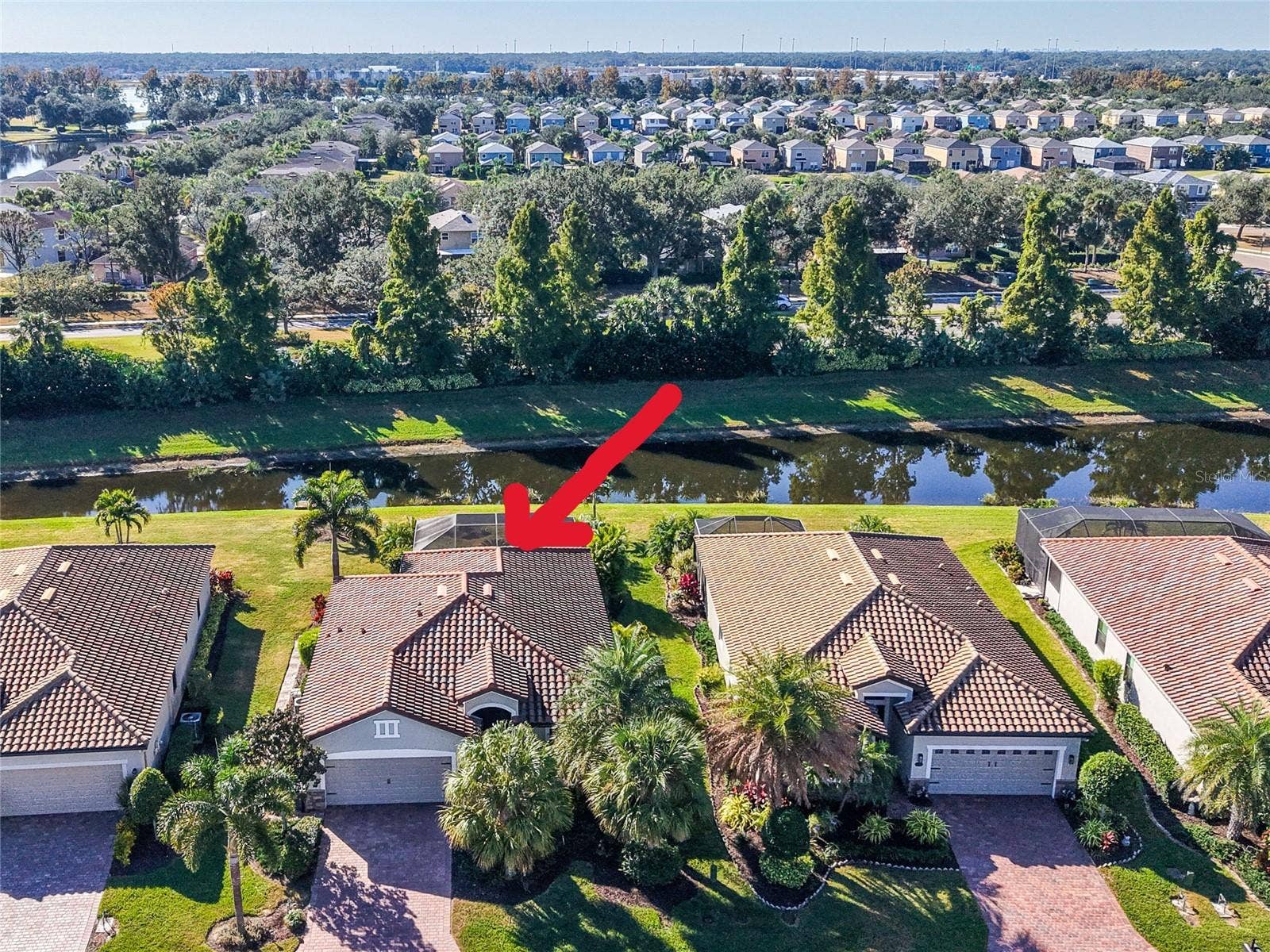 7124 MARSH VIEW TERRACE STREET, Bradenton, FL 34212 Aerial view of house facing south, pond, trees
