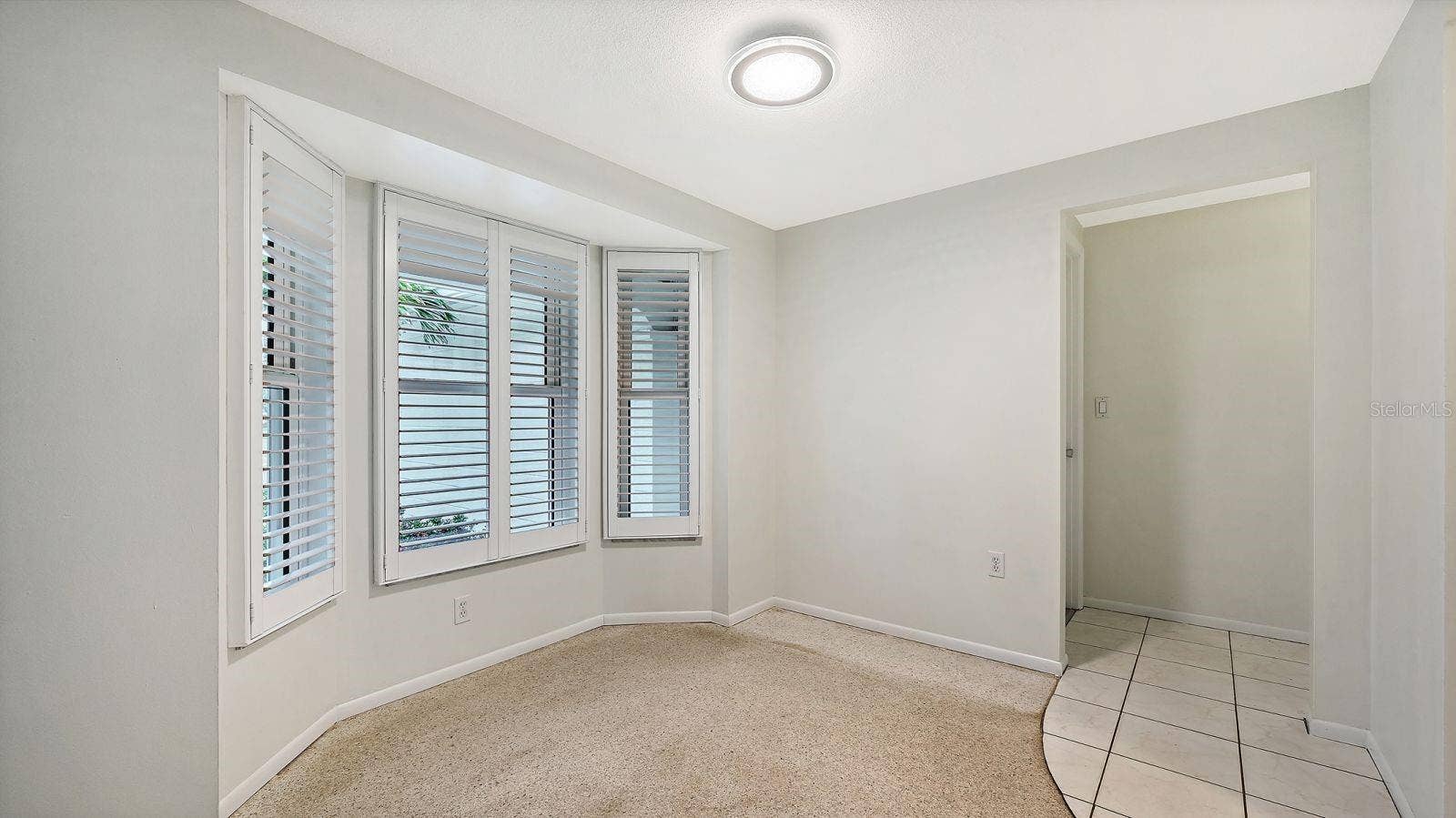 Dining Room with a Bay Window with Plantation Shutters