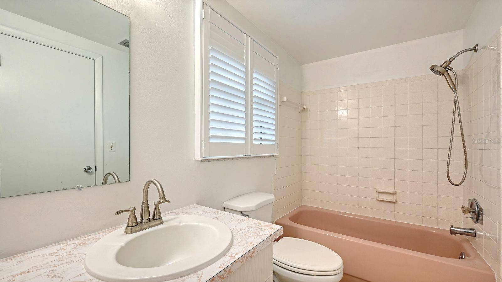 Primary Bathroom with a Tub/Shower Combo.