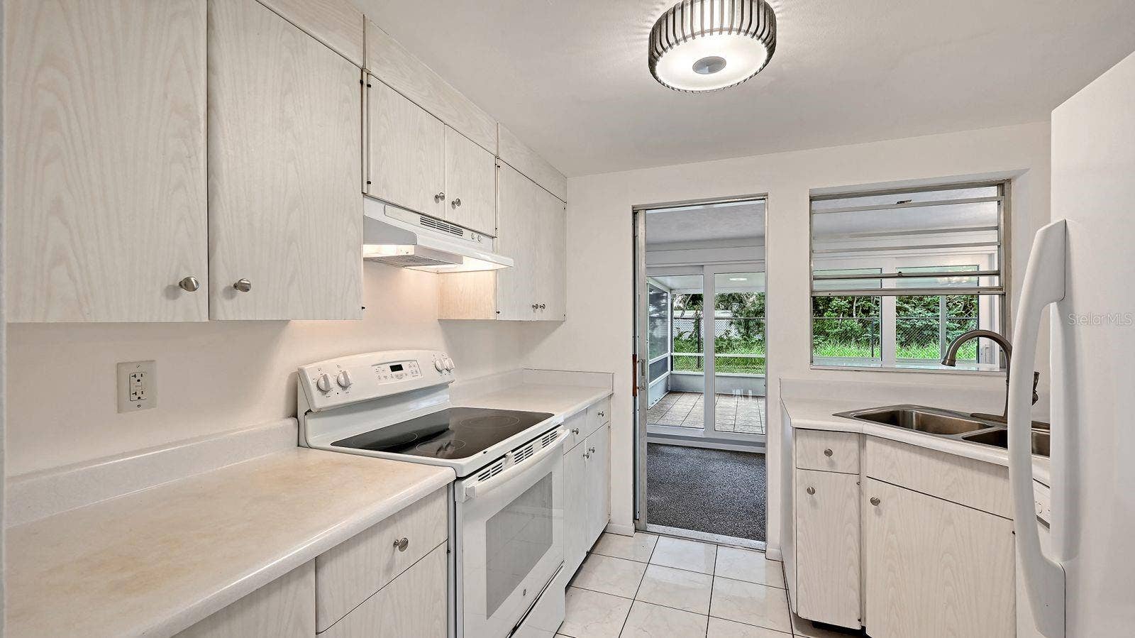 Kitchen with pass thru window and door to the Florida Room