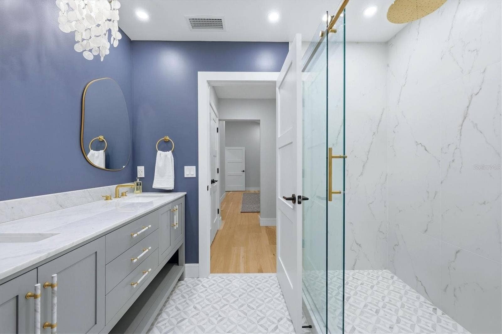 2141 HARBOURSIDE DRIVE, #1203, Longboat Key, FL 34228 Primary Bathroom with Double Sinks and Carerra Marble vanity top and glass enclosure shower