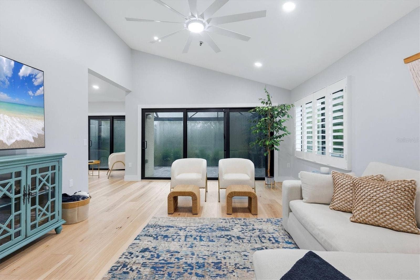 2141 HARBOURSIDE DRIVE, #1203, Longboat Key, FL 34228 Living room opens to lanai with new screened enclosure and new stone pavers