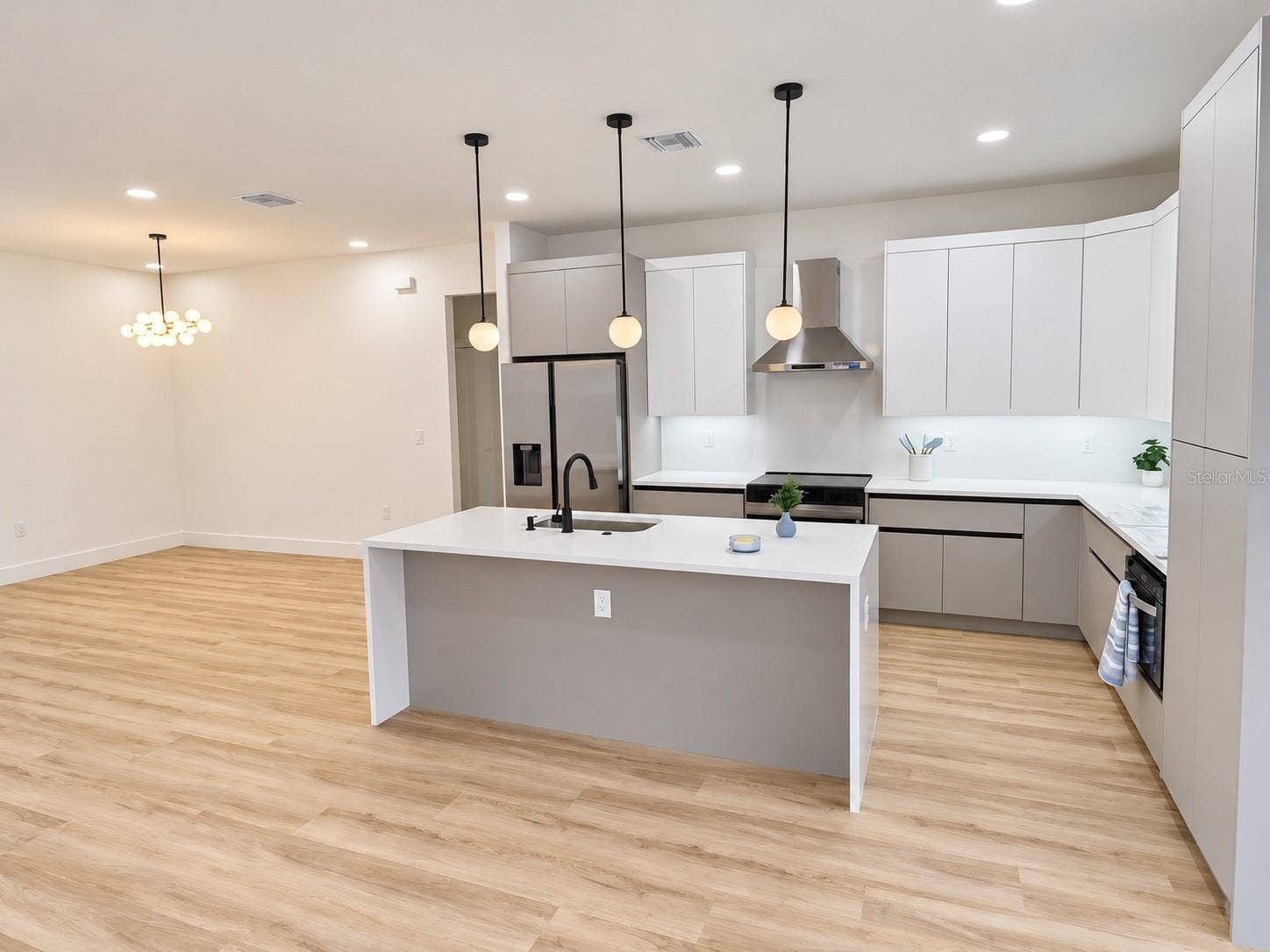 3126 BELLEVILLE TER, North Port, FL 34286 Open-concept kitchen with a large island and pendant lighting.