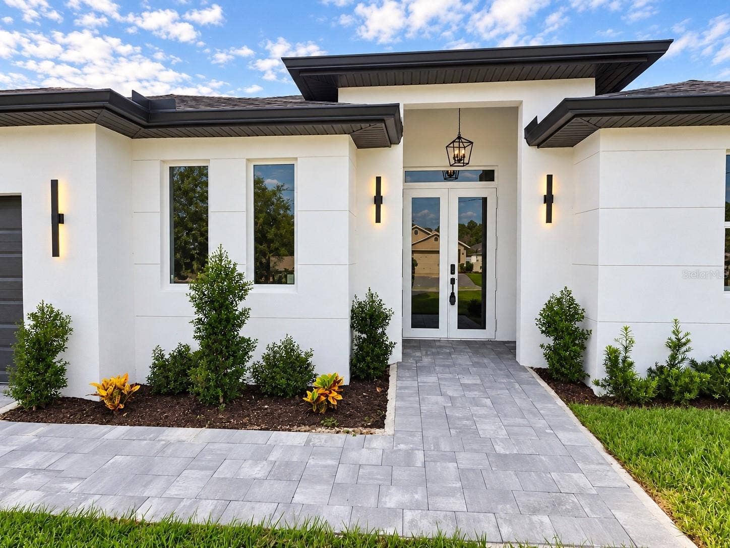 3126 BELLEVILLE TER, North Port, FL 34286 Welcoming covered entry with modern architectural details.