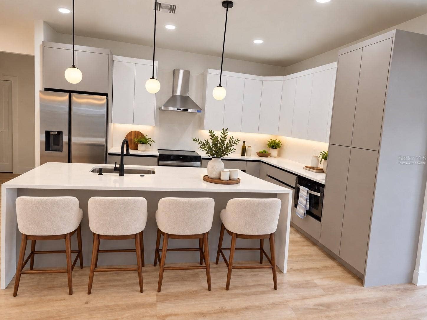 3126 BELLEVILLE TER, North Port, FL 34286 Virtually staged kitchen featuring an island with seating for four.