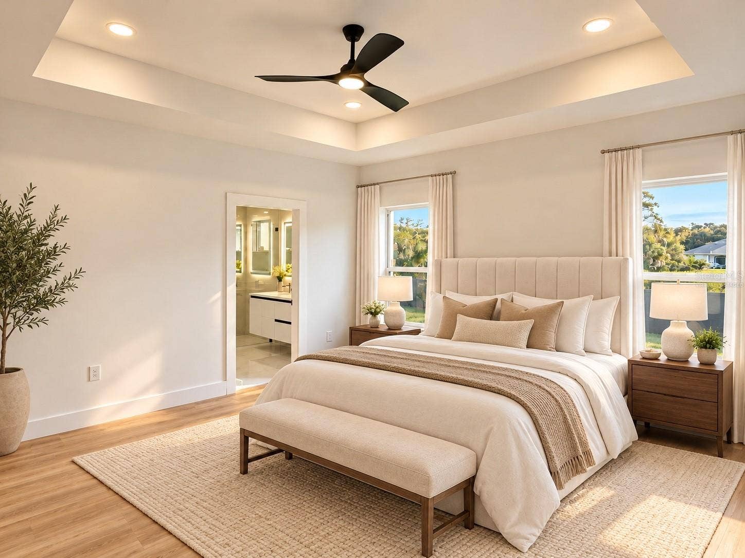 3126 BELLEVILLE TER, North Port, FL 34286 Virtually staged primary bedroom with a tray ceiling and ceiling fan.