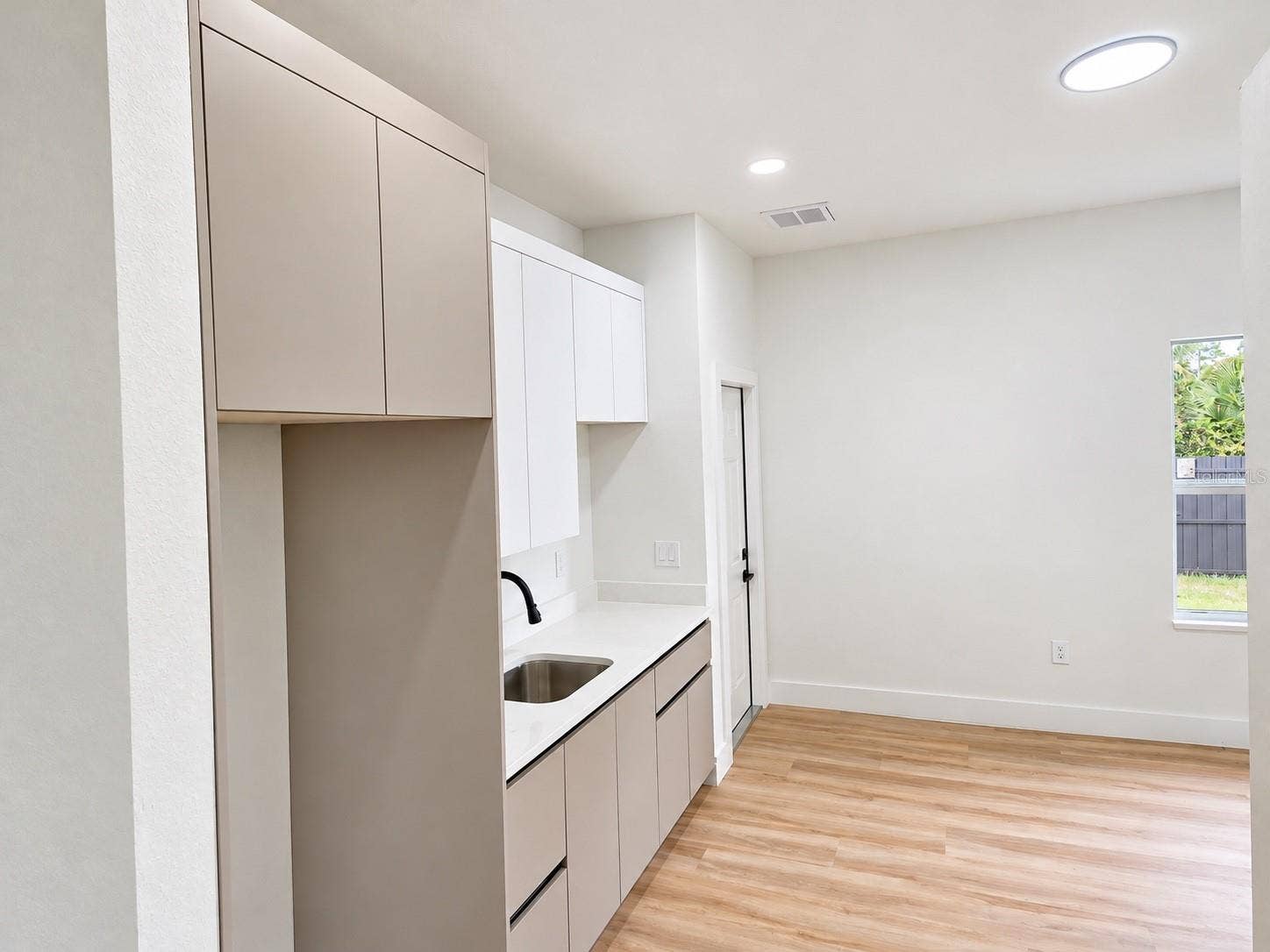 3126 BELLEVILLE TER, North Port, FL 34286 Private in-law suite featuring a kitchenette and flexible living space.