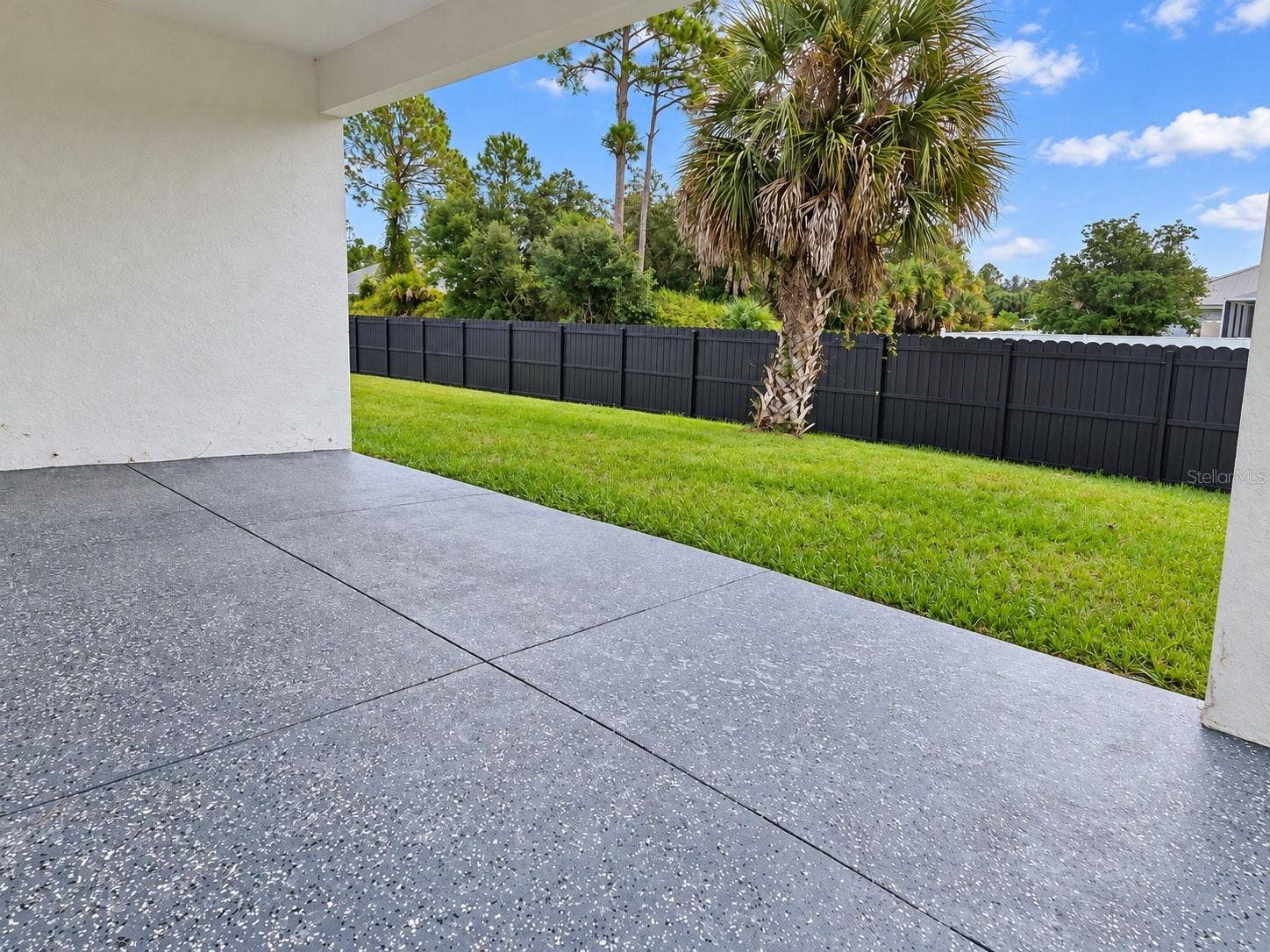 3126 BELLEVILLE TER, North Port, FL 34286 Covered rear patio overlooking the spacious backyard.