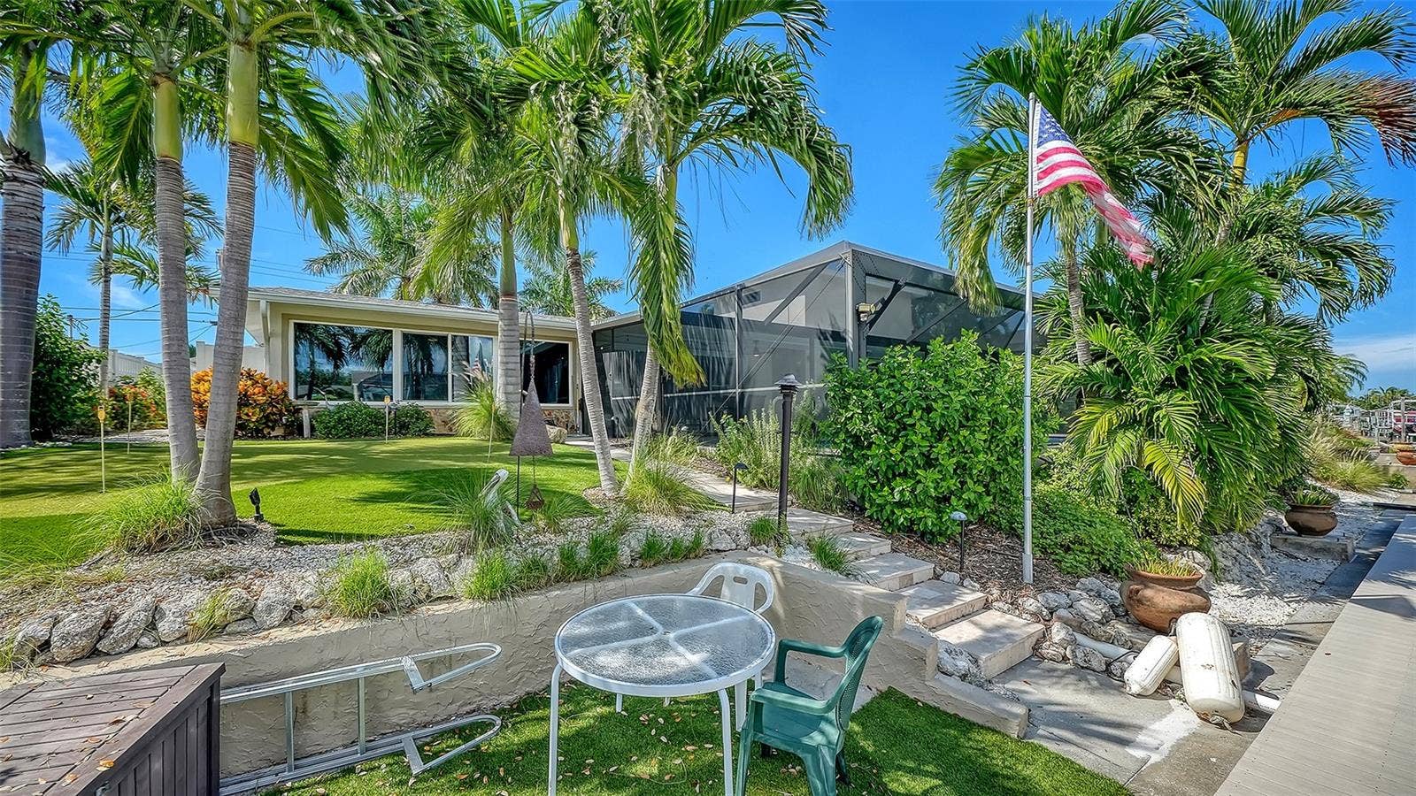 4907 CORAL BOULEVARD, Bradenton, FL 34210 Enjoy a relaxed waterside seat beneath the palms.