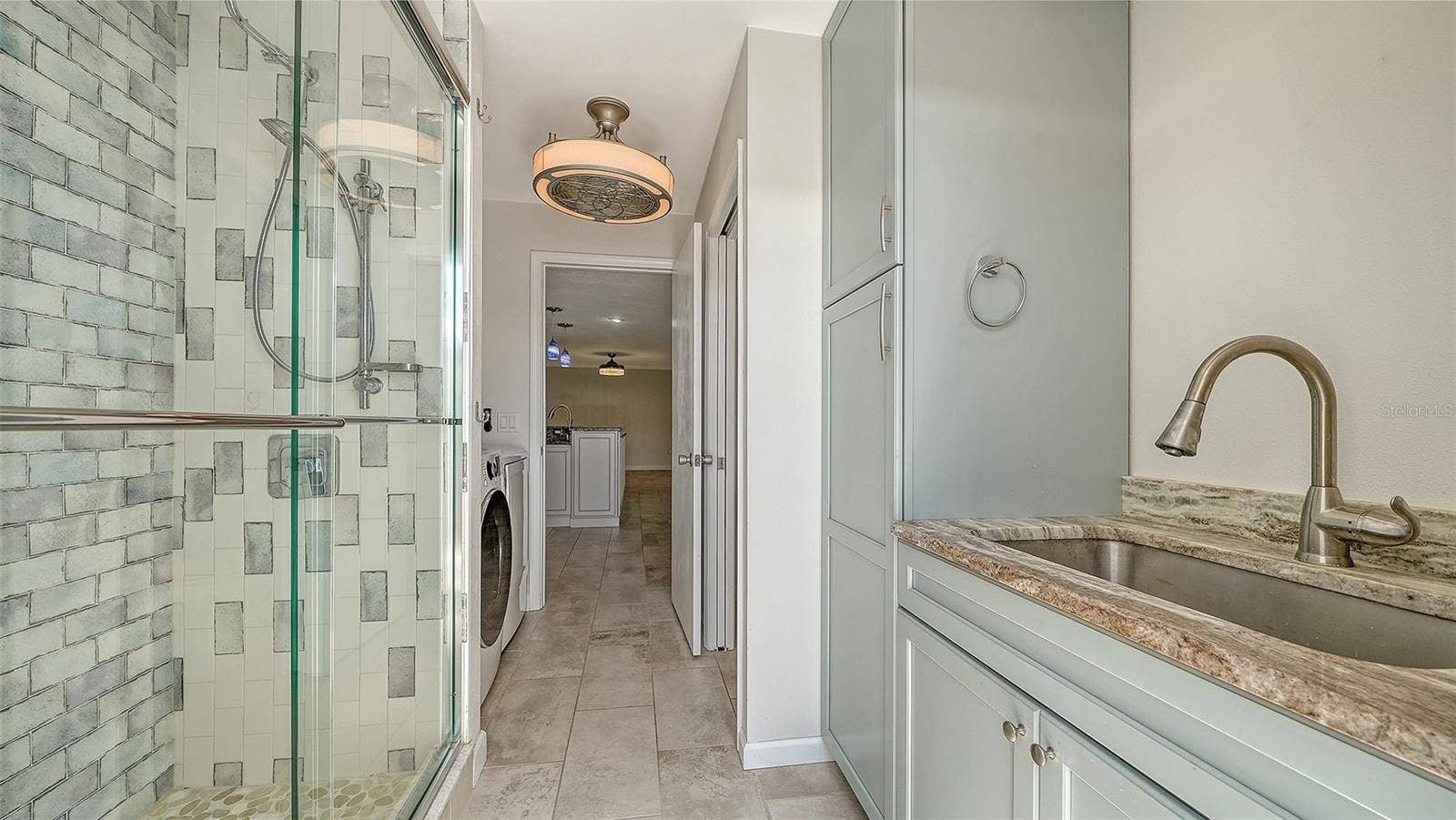 4907 CORAL BOULEVARD, Bradenton, FL 34210 A poolside bathroom with a glass shower for easy refreshment.