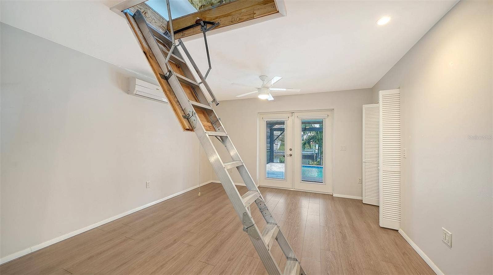 4907 CORAL BOULEVARD, Bradenton, FL 34210 Pull-down stairs provide access to the overhead storage area.