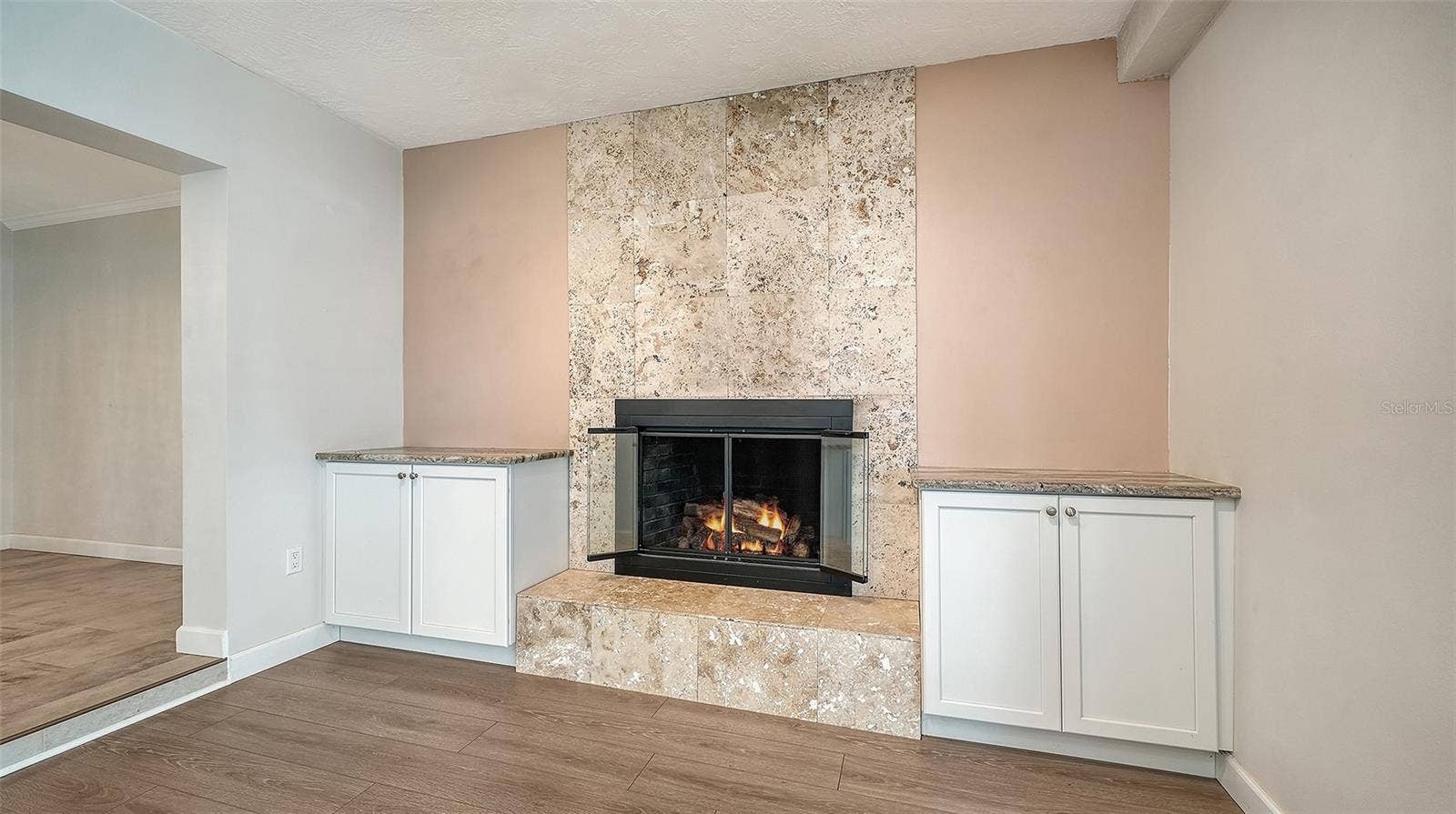 4907 CORAL BOULEVARD, Bradenton, FL 34210 A fireplace feature wall creates a natural gathering spot.
