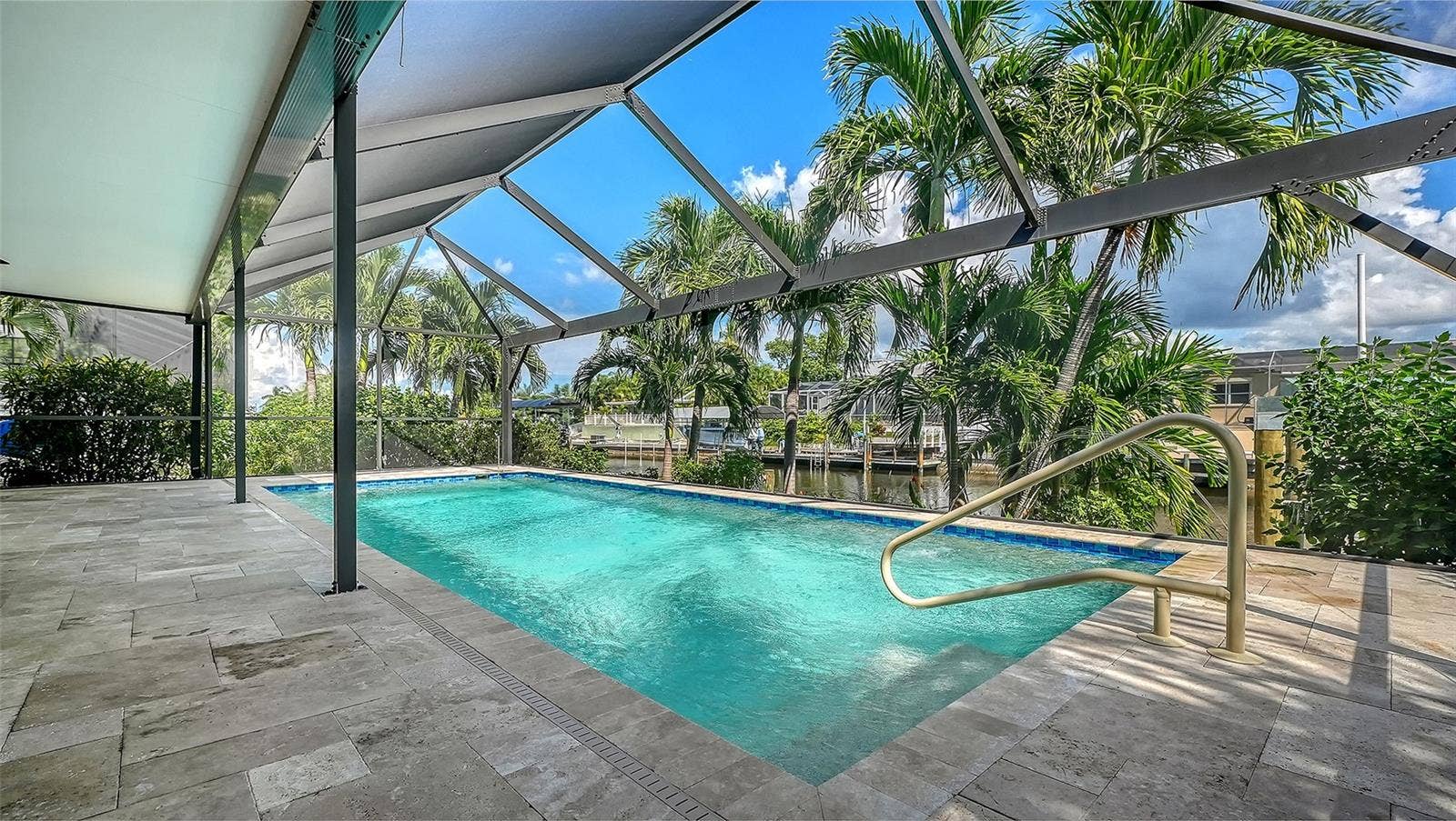 4907 CORAL BOULEVARD, Bradenton, FL 34210 Tropical greenery surrounds your screened pool retreat for privacy.