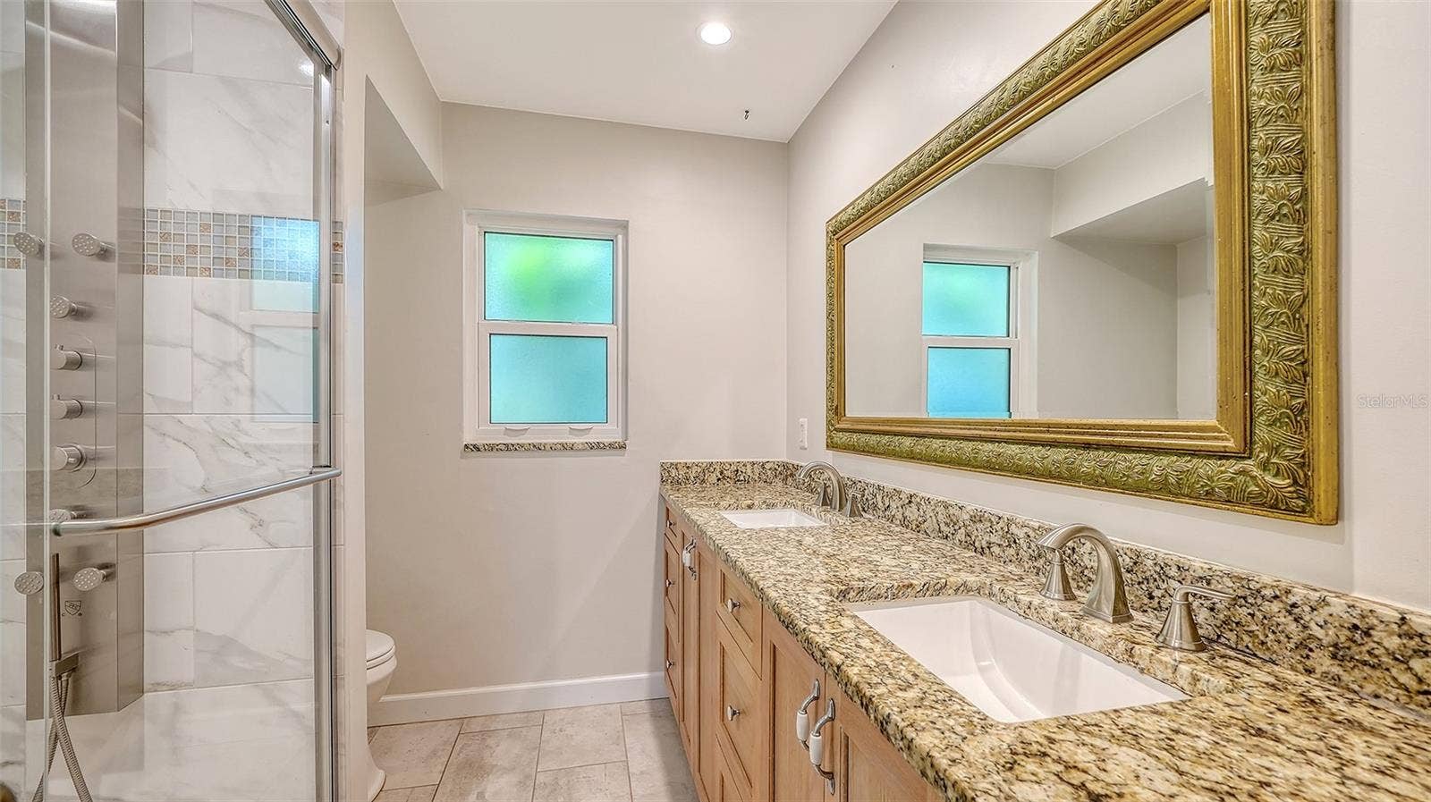 4907 CORAL BOULEVARD, Bradenton, FL 34210 A spacious vanity and glass shower for daily comfort.