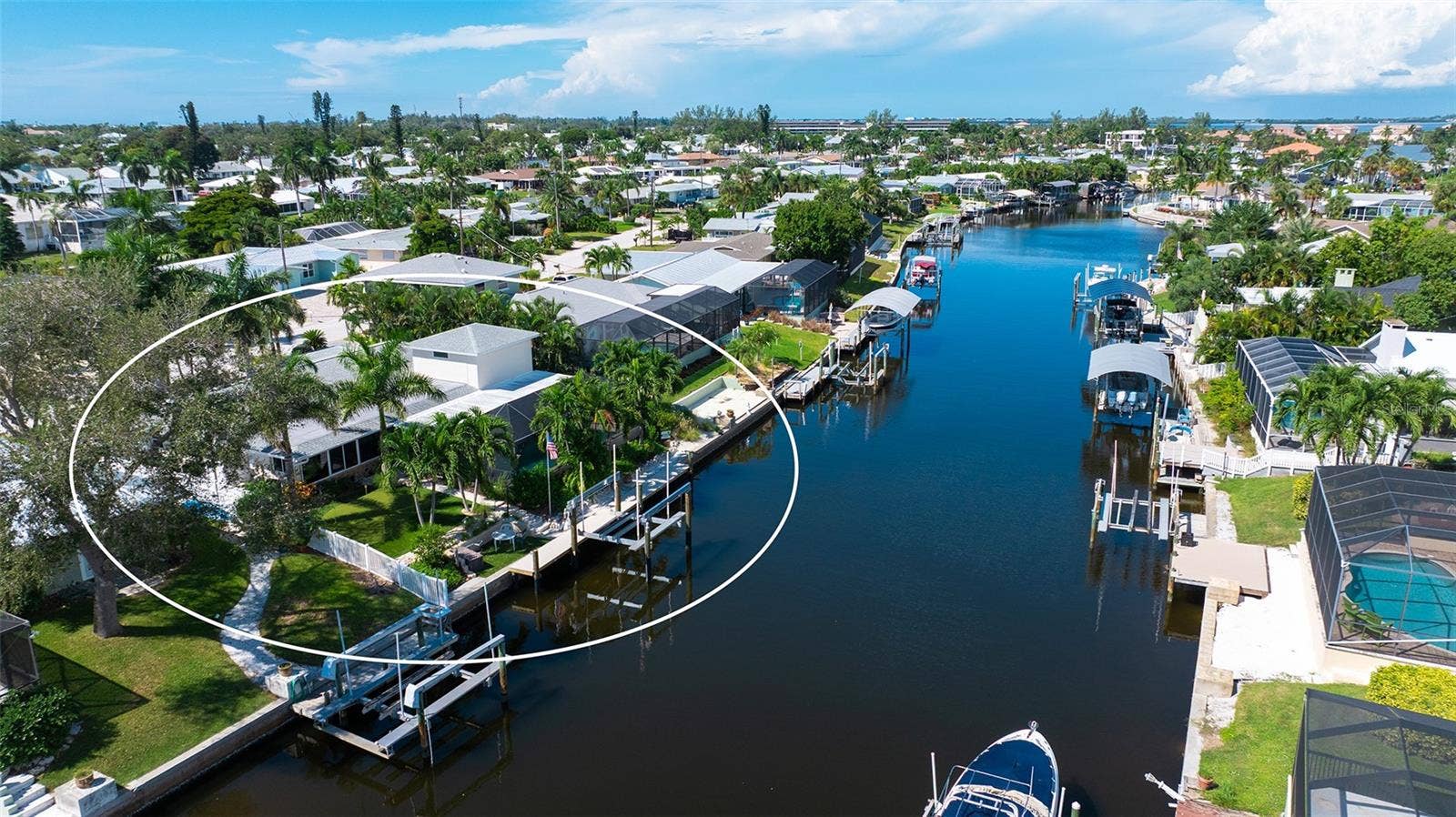 4907 CORAL BOULEVARD, Bradenton, FL 34210 A rear aerial highlights the home and its canal-side setting.