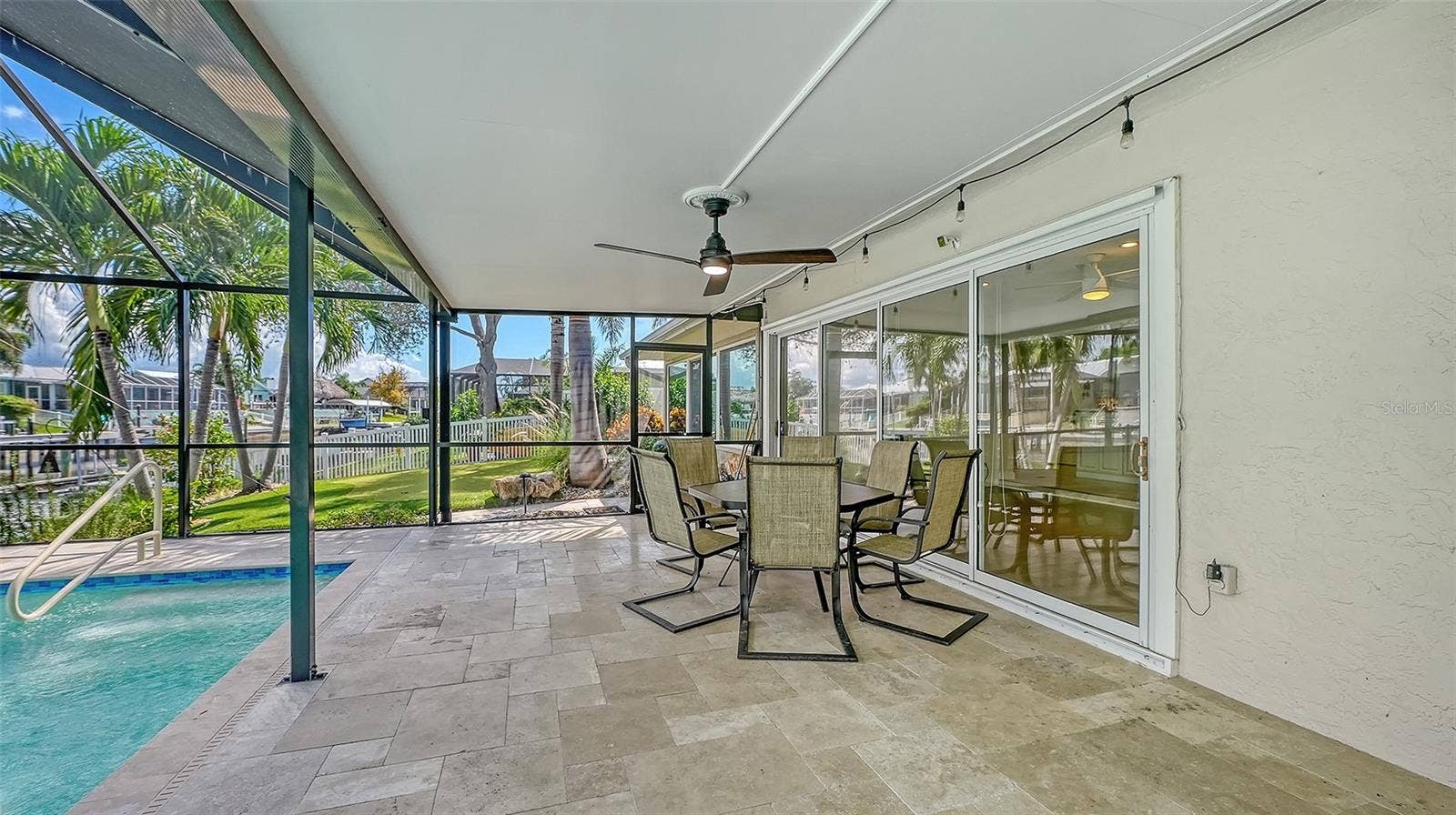 4907 CORAL BOULEVARD, Bradenton, FL 34210 Covered outdoor dining with views of the pool and canal.