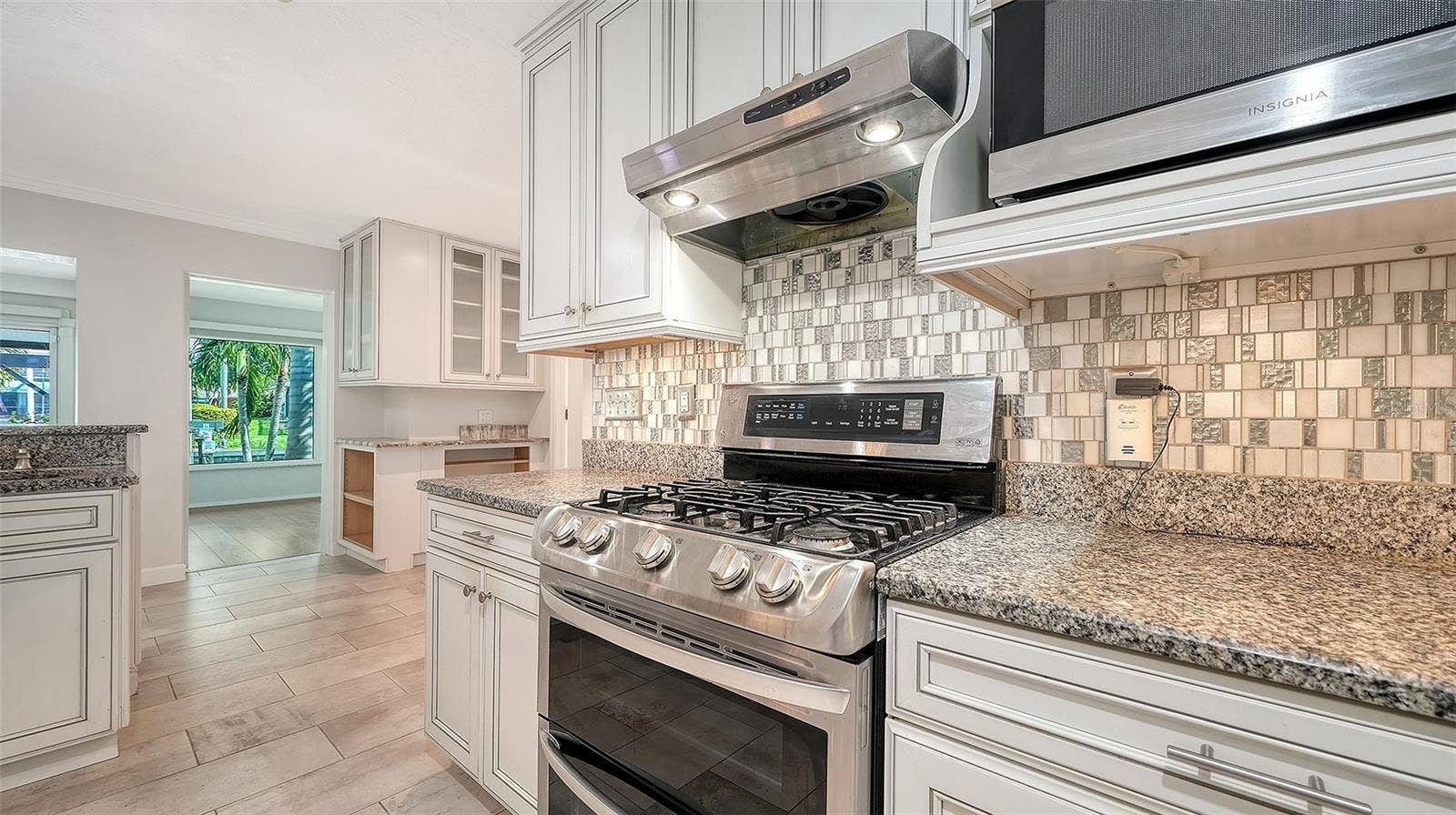 4907 CORAL BOULEVARD, Bradenton, FL 34210 A gas range and detailed tile backsplash anchor the kitchen.