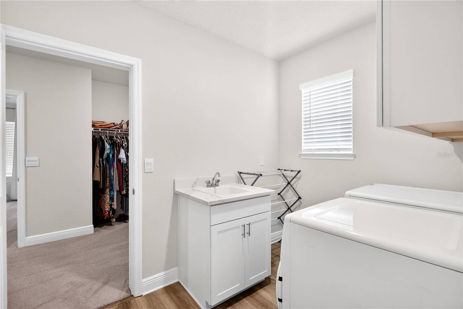 Laundry room off primary bed closet