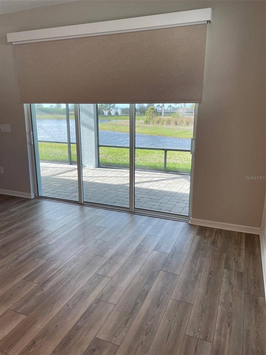 10434 SPRING TIDE WAY, Parrish, FL 34219 Remote control custom blind at patio door.