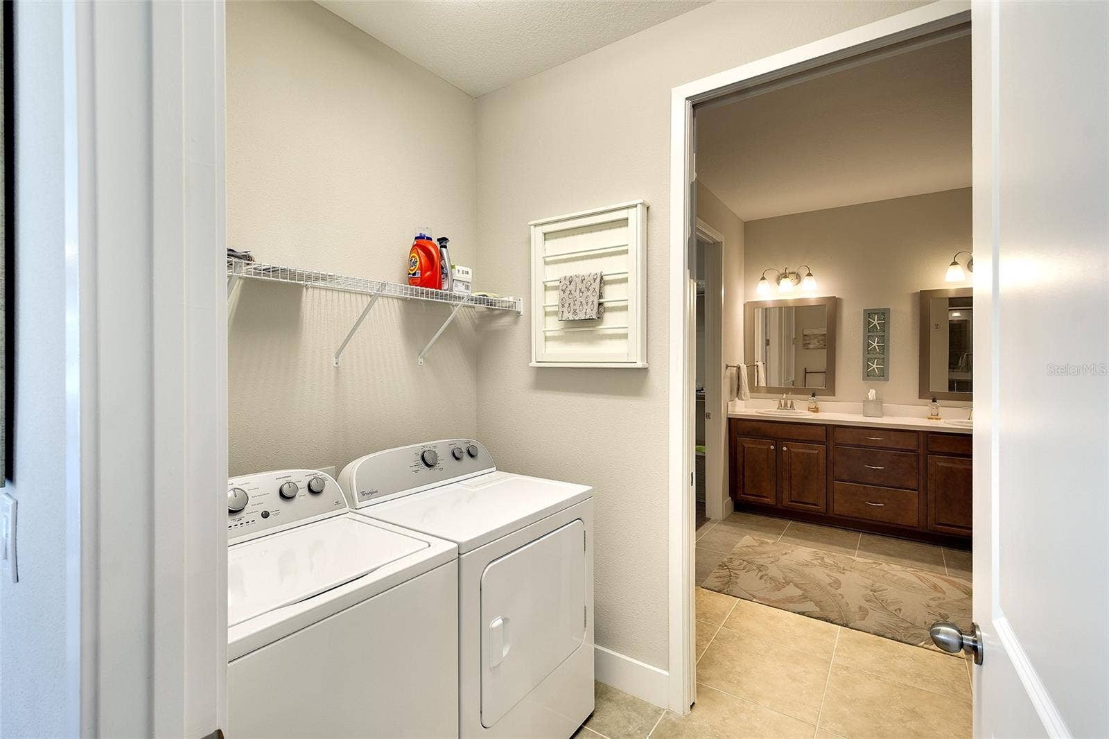 Pass through laundry room, conveniently located to kitchen and owner's bath