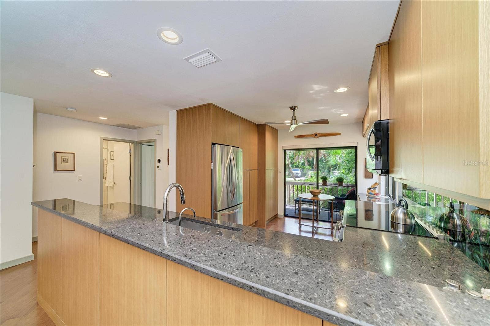 2403 ARBORETUM CIRCLE, #29, Sarasota, FL 34232 Kitchen with sliders to the front screened porch