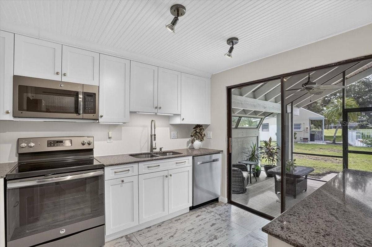 2319 LAKESIDE MEWS, #B3, Sarasota, FL 34235 kitchen with slider to the lanai
