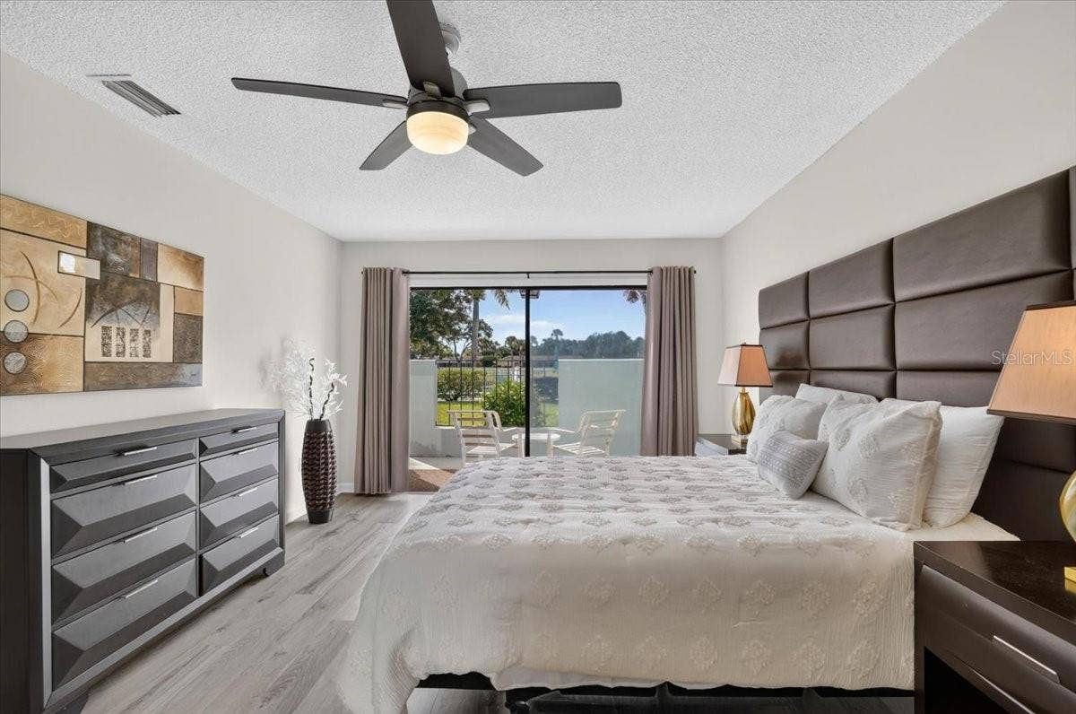 2319 LAKESIDE MEWS, #B3, Sarasota, FL 34235 master bedroom with sliders to the patio