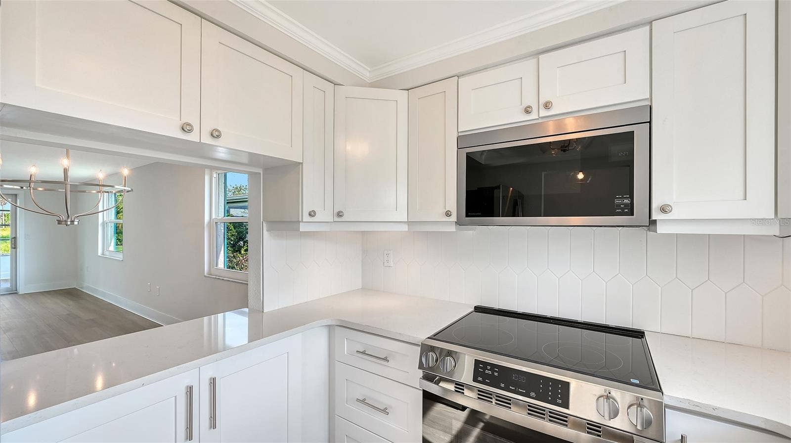 New Kitchen with stone countertops and stainless steel appliances. Pass through to Dining Room.