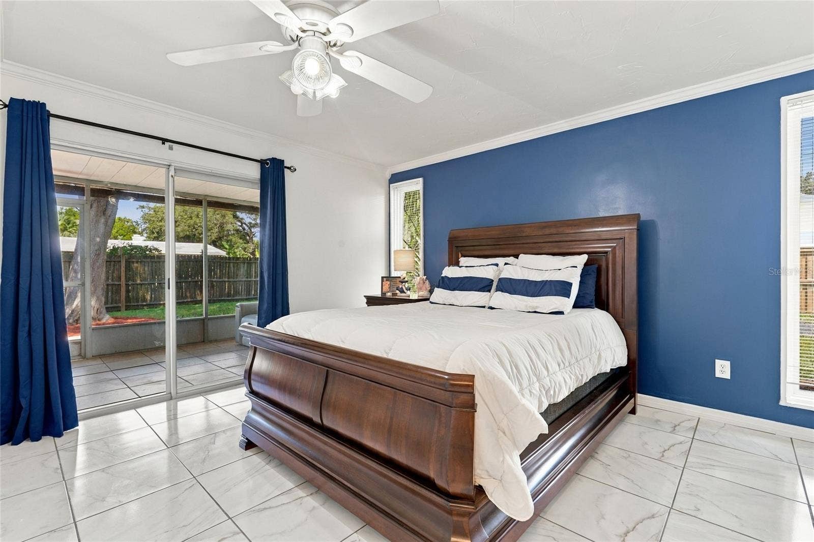 Spacious Primary Bedroom with Direct Access to the Screened-In Lanai