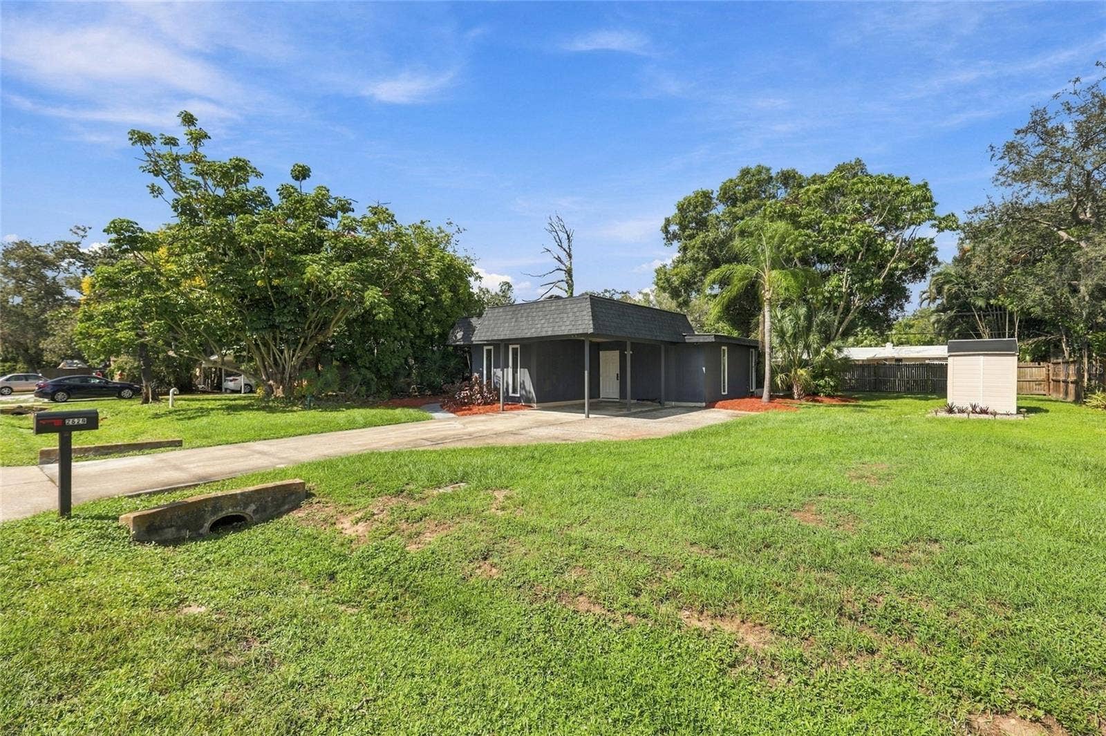 Front Exterior with covered carport and large yard