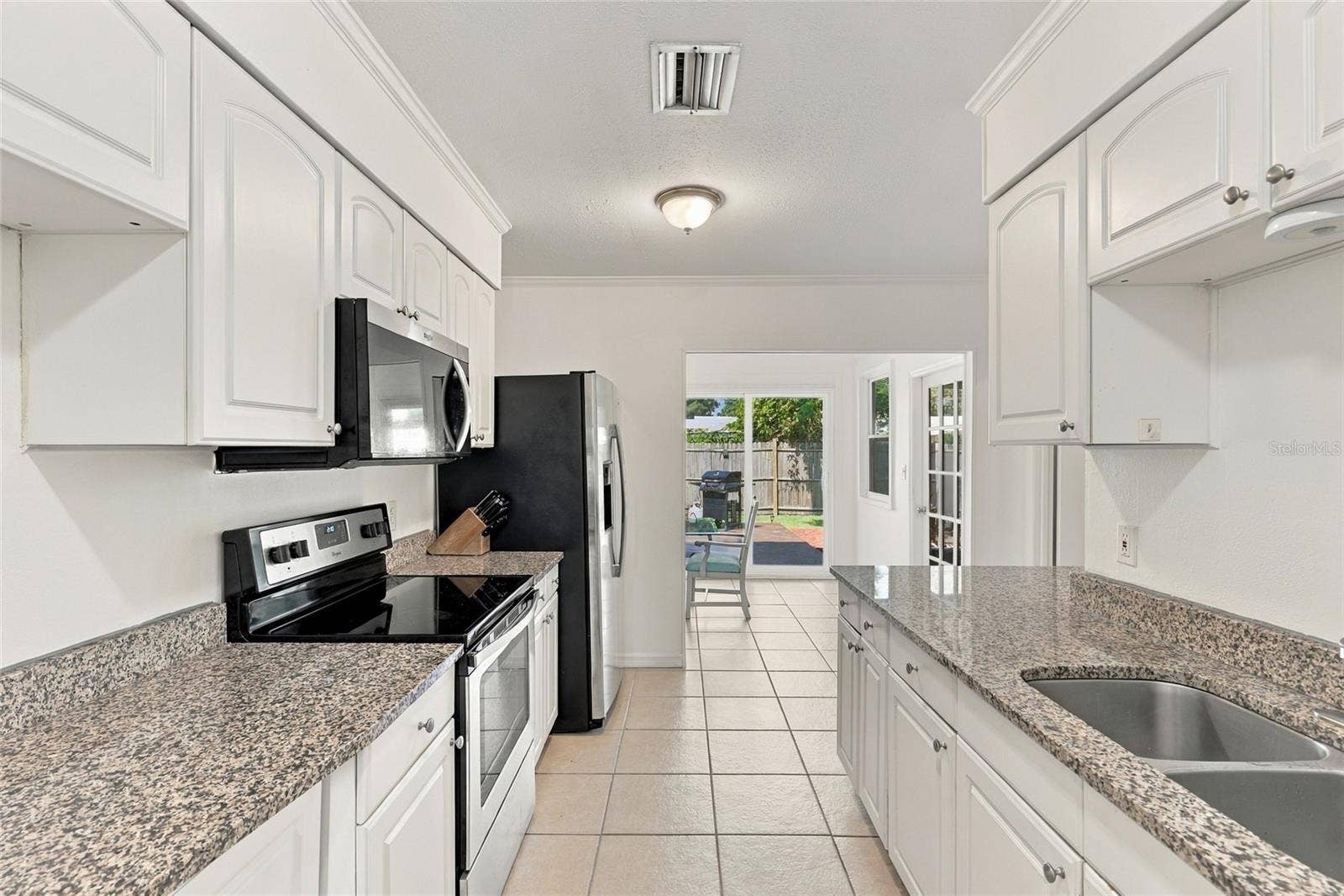 Galley-Style Kitchen Featuring Granite Countertops