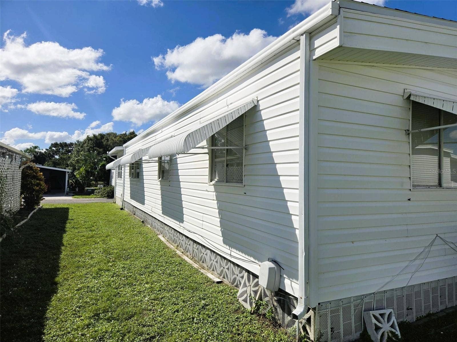 3309 OAKWOOD BOULEVARD N, Sarasota, FL 34237 right side of home with shutters