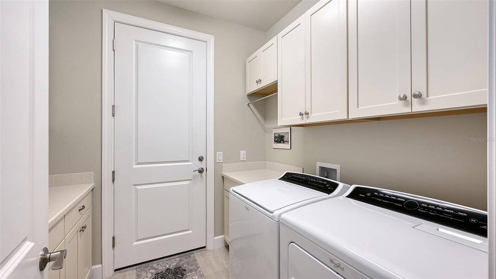 6827 GOSPORT COVE, Bradenton, FL 34202 This exceptional laundry room has built-in cabinets on both side of the room for additional storage for your convenience.