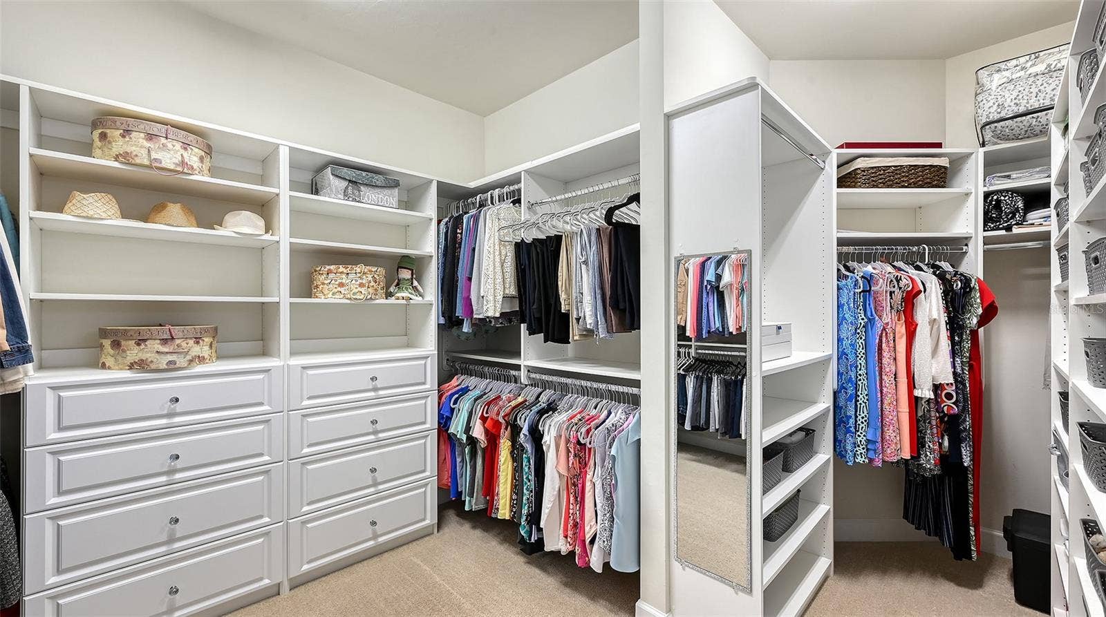 6827 GOSPORT COVE, Bradenton, FL 34202 Primary closet with custom built-ins with an abundant amount of space for true luxury living.