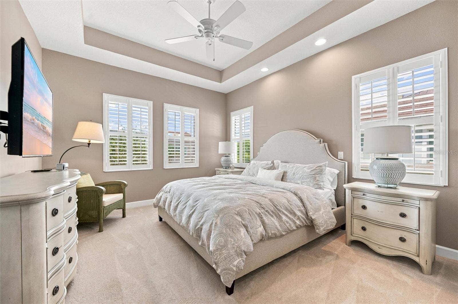 291 COMPASS POINT DRIVE, #201, Bradenton, FL 34209 Spacious primary suite, featuring an elegant tray ceiling and two walk-in closets for ample storage.
