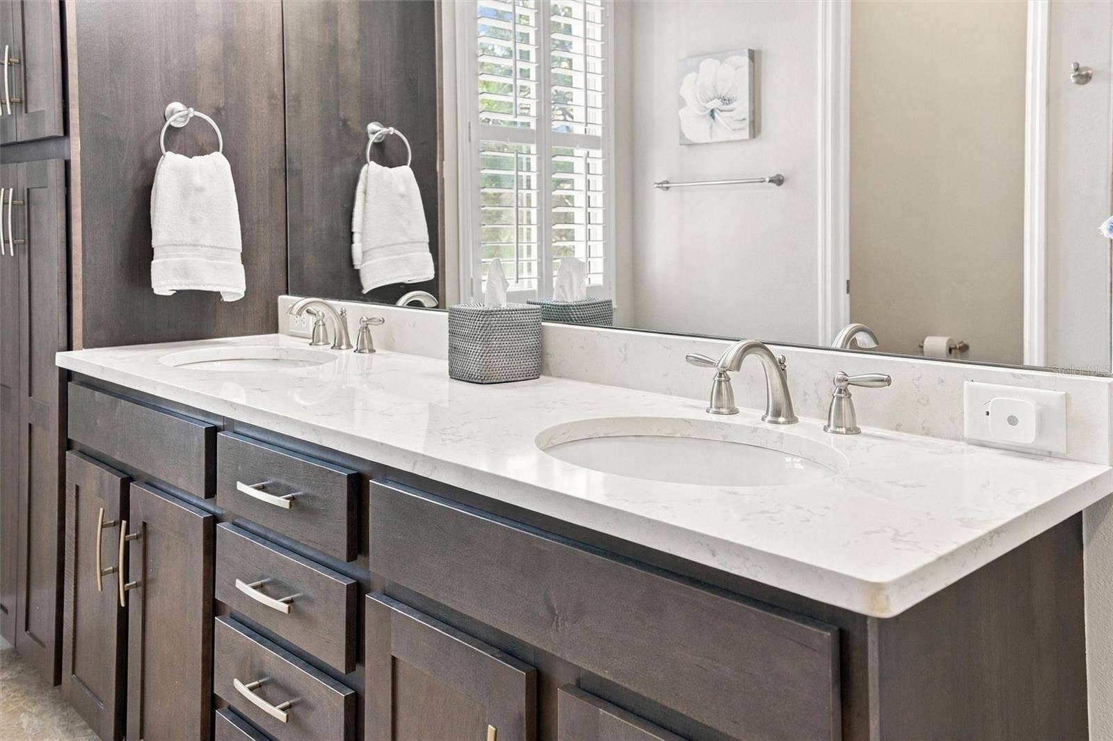 291 COMPASS POINT DRIVE, #201, Bradenton, FL 34209 The spacious primary ensuite features dual vanities, a large walk-in shower, a private water closet, and convenient access to one of the suites two walk-in closets.