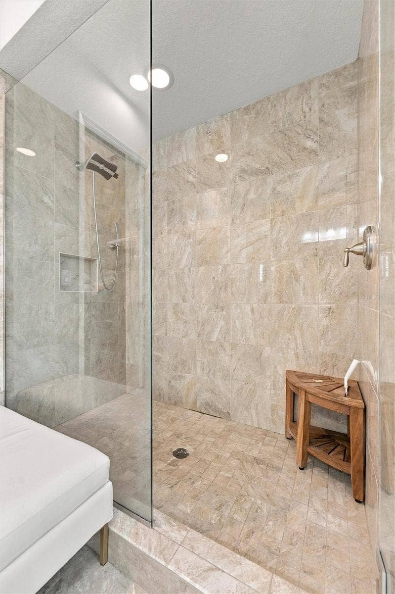 291 COMPASS POINT DRIVE, #201, Bradenton, FL 34209 The spacious primary ensuite features dual vanities, a large walk-in shower, a private water closet, and convenient access to one of the suites two walk-in closets.