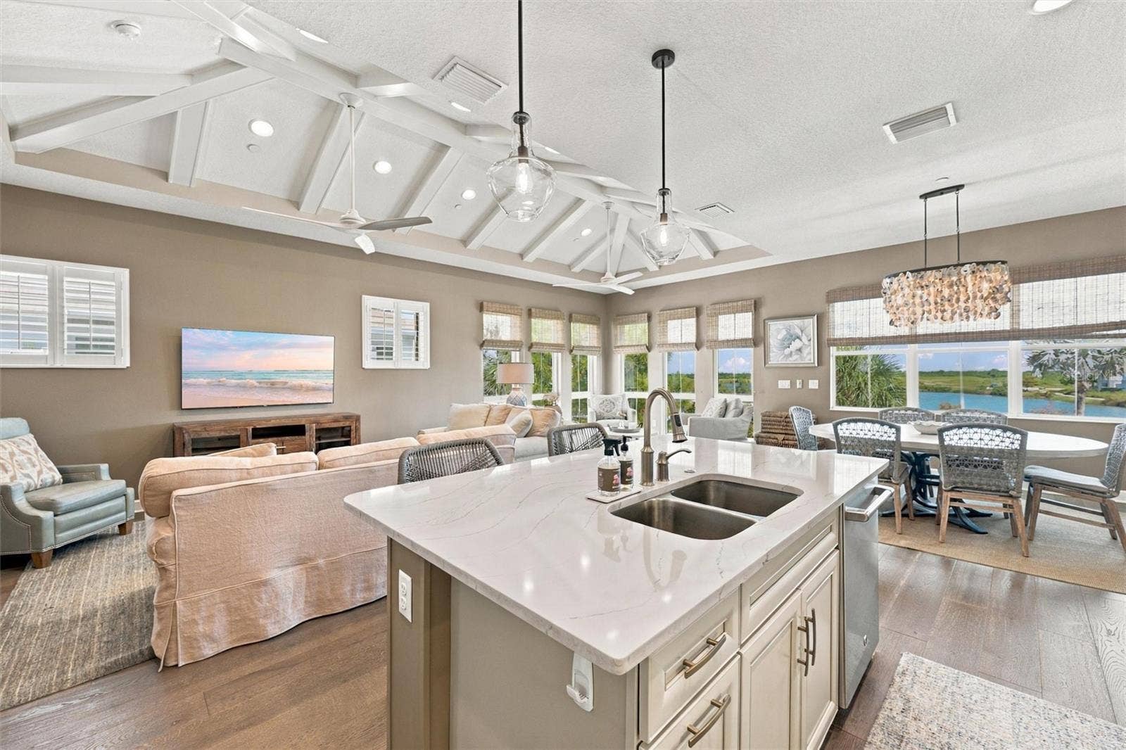291 COMPASS POINT DRIVE, #201, Bradenton, FL 34209 Enjoy peaceful Sapphire Lake views from this beautifully appointed home, featuring an open-concept floor plan, soaring vaulted ceilings, and Mohawk engineered hardwood flooring.