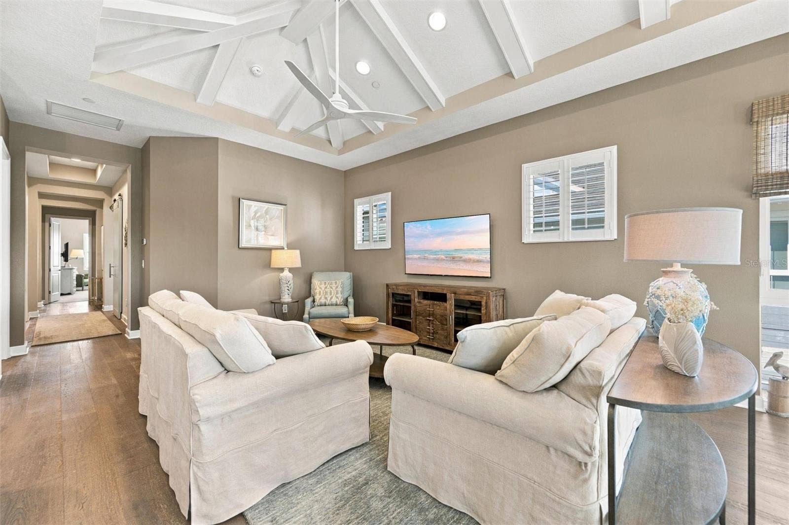 291 COMPASS POINT DRIVE, #201, Bradenton, FL 34209 Enjoy peaceful Sapphire Lake views from this beautifully appointed home, featuring an open-concept floor plan, soaring vaulted ceilings, and Mohawk engineered hardwood flooring.