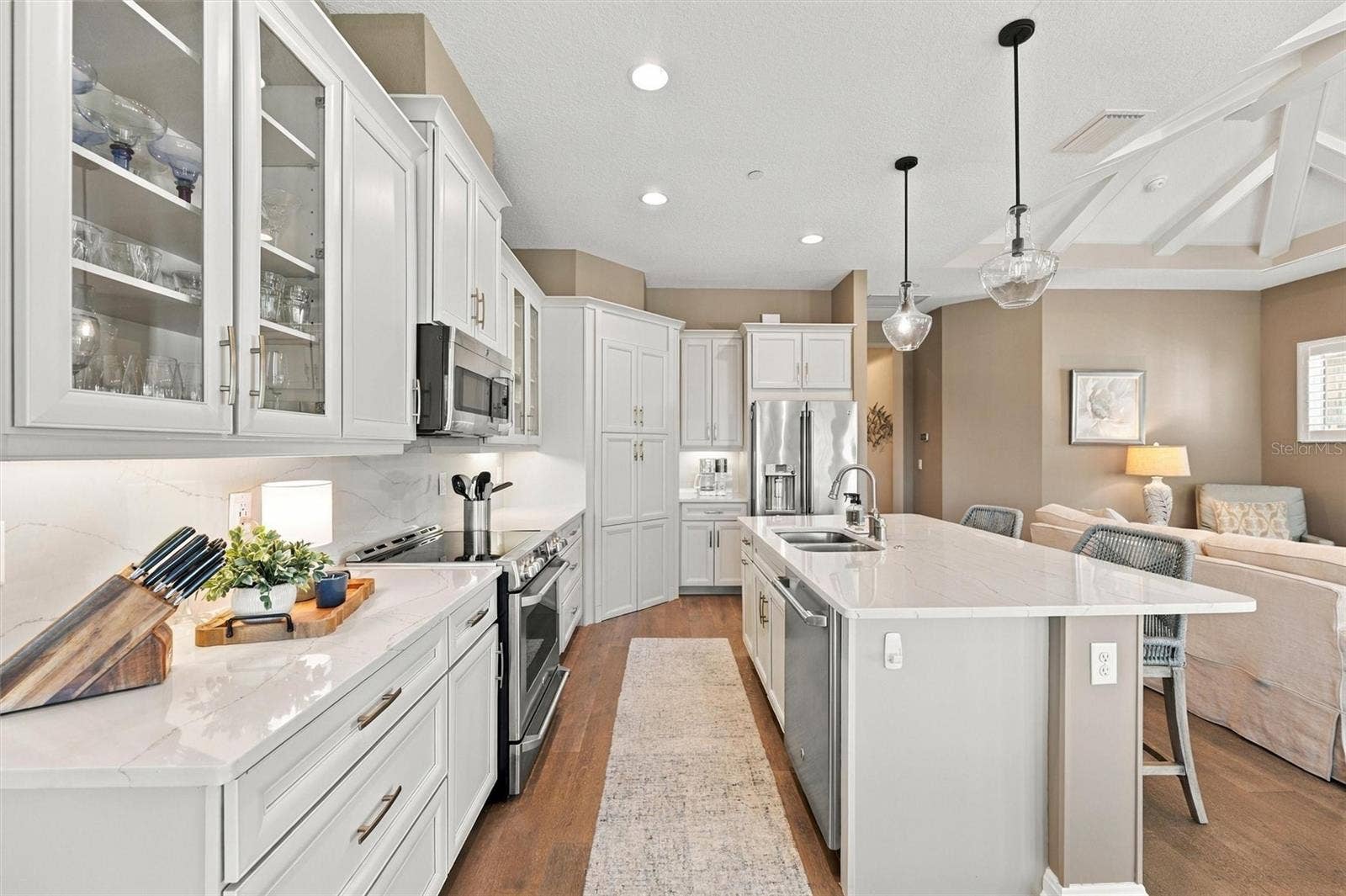 291 COMPASS POINT DRIVE, #201, Bradenton, FL 34209 The well-designed kitchen shines with GE Caf stainless steel appliances, elegant quartz countertops, and a spacious walk-in pantry.