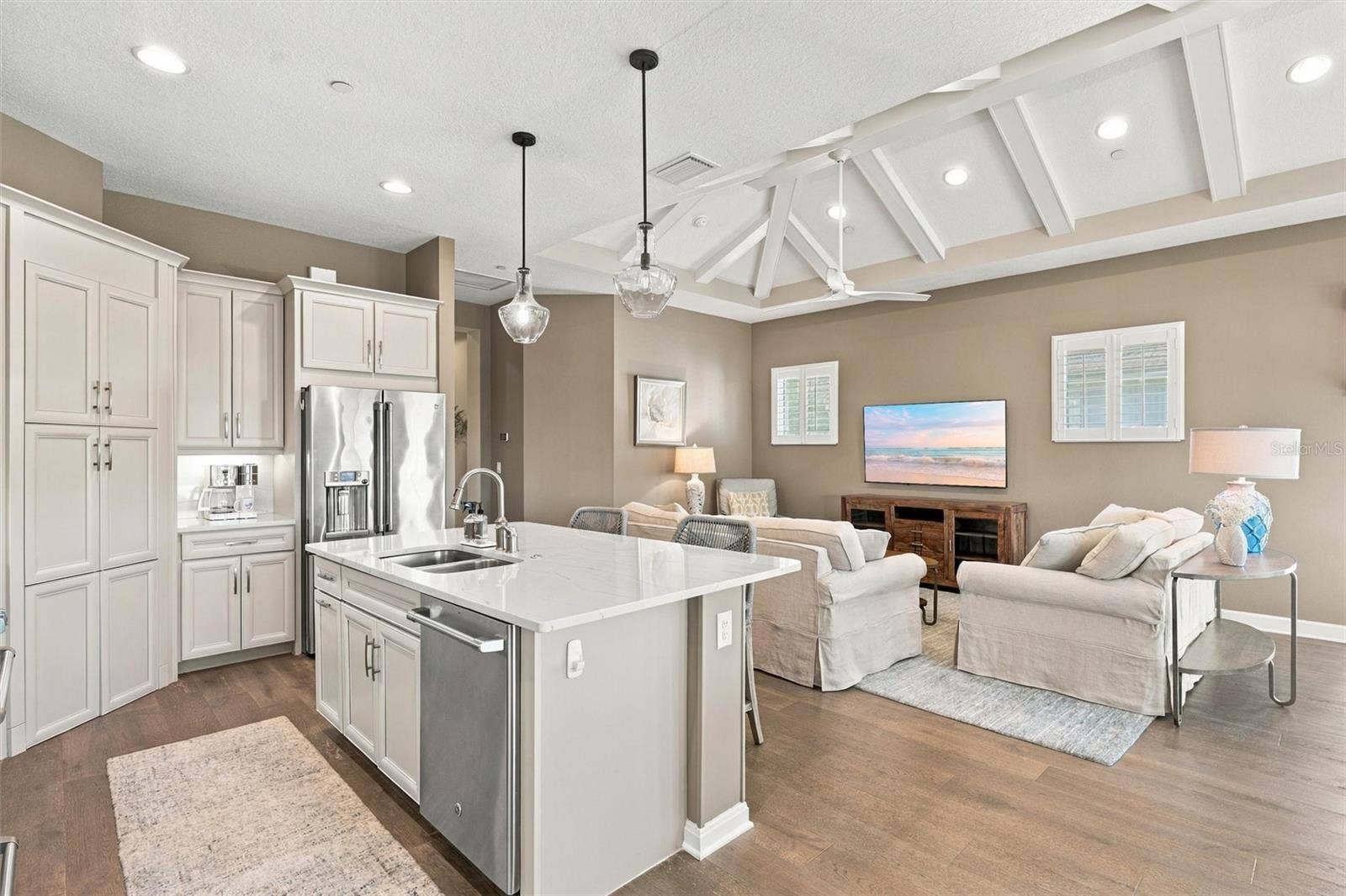 291 COMPASS POINT DRIVE, #201, Bradenton, FL 34209 The well-designed kitchen shines with GE Caf stainless steel appliances, elegant quartz countertops, and a spacious walk-in pantry.