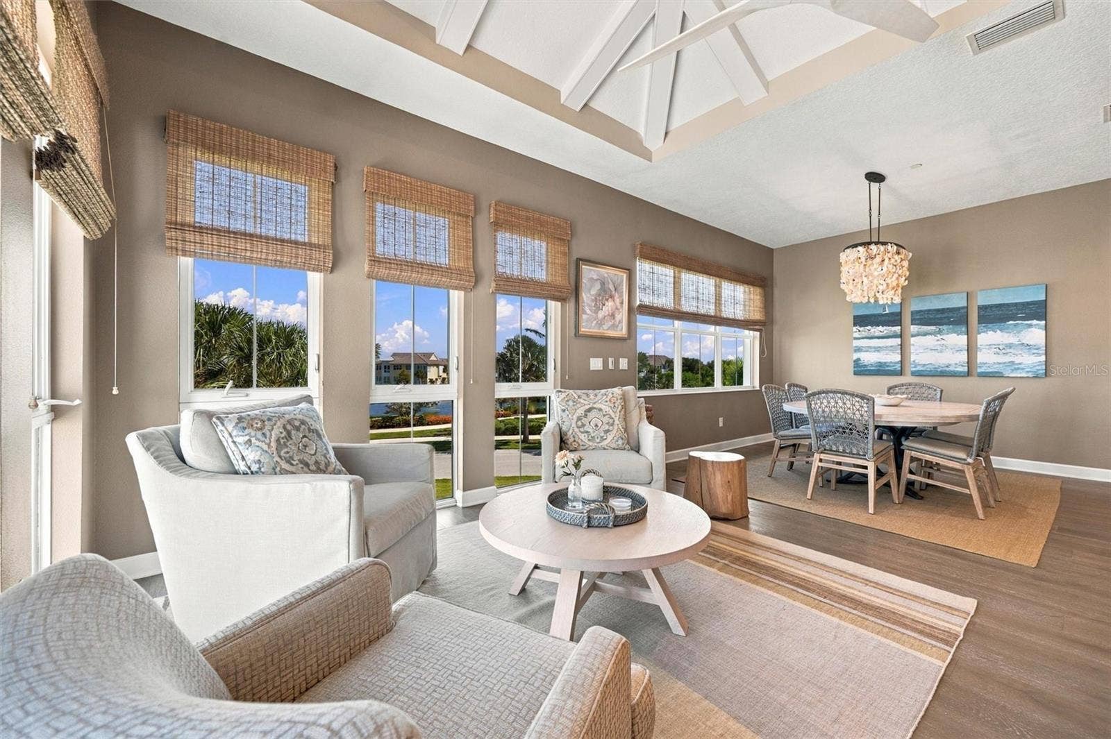291 COMPASS POINT DRIVE, #201, Bradenton, FL 34209 Enjoy peaceful Sapphire Lake views from this beautifully appointed home, featuring an open-concept floor plan, soaring vaulted ceilings, and Mohawk engineered hardwood flooring.