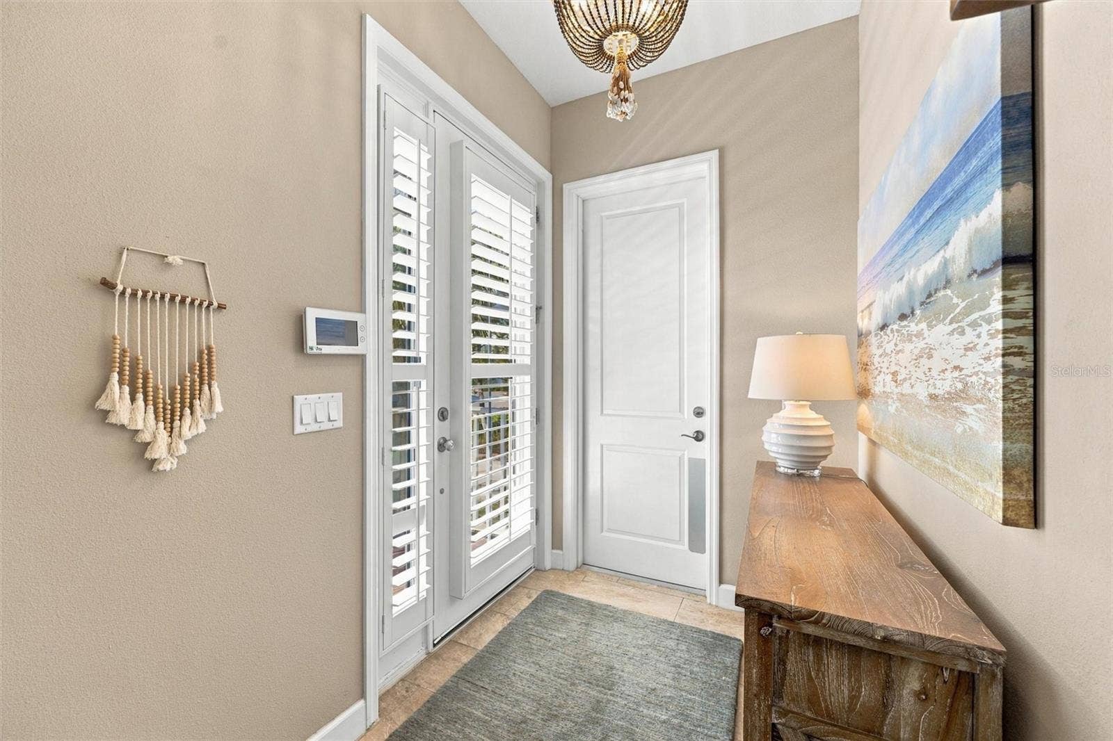 291 COMPASS POINT DRIVE, #201, Bradenton, FL 34209 Welcome through the front entry, with convenient access to the second level by either stairs or elevator.