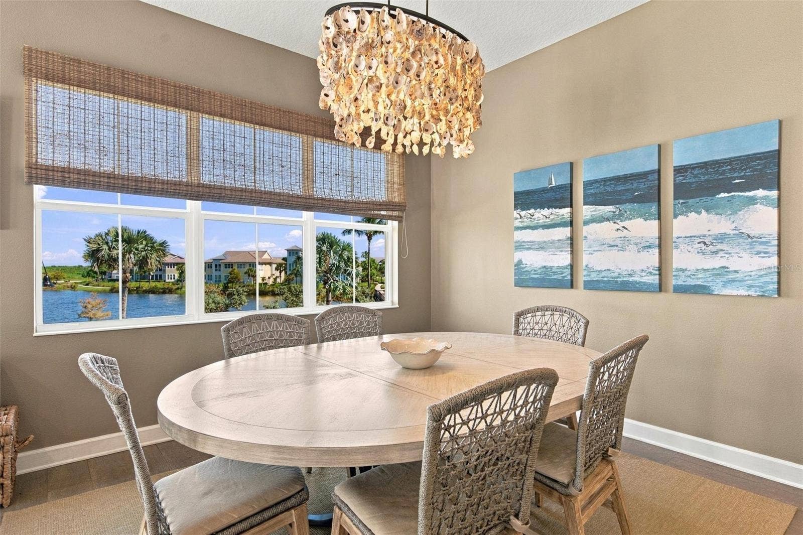 291 COMPASS POINT DRIVE, #201, Bradenton, FL 34209 Enjoy peaceful Sapphire Lake views from this beautifully appointed home, featuring an open-concept floor plan, soaring vaulted ceilings, and Mohawk engineered hardwood flooring.