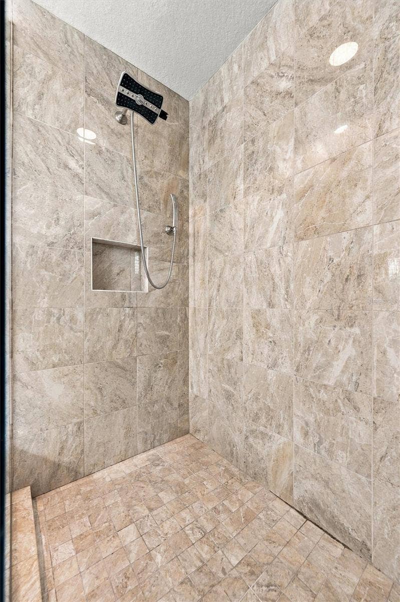 291 COMPASS POINT DRIVE, #201, Bradenton, FL 34209 The spacious primary ensuite features dual vanities, a large walk-in shower, a private water closet, and convenient access to one of the suites two walk-in closets.