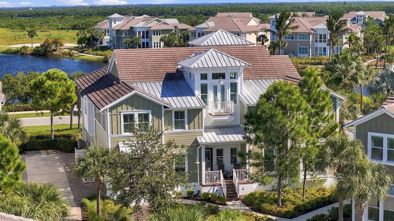 291 COMPASS POINT DRIVE, #201, Bradenton, FL 34209 Turnkey-furnished 2-bedroom, 2-bath Bermuda coach home featuring a versatile bonus roomperfect for a den, home office, or additional bedroom!