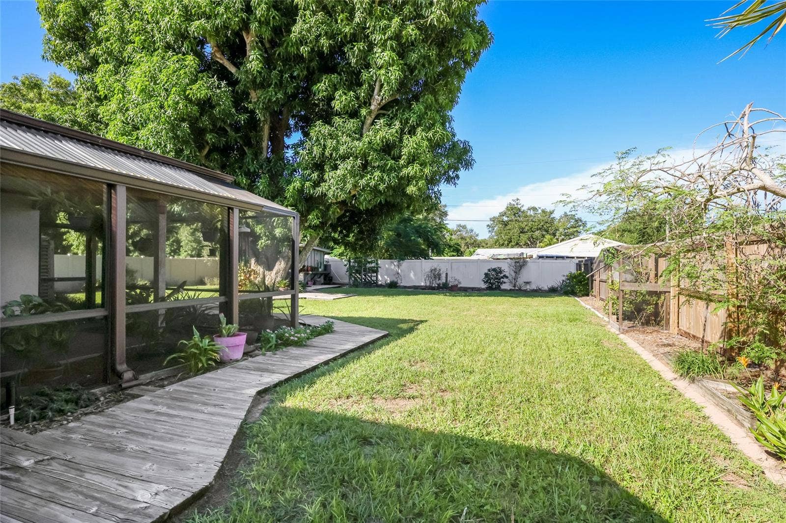 204 46TH STREET NW, Bradenton, FL 34209 This backyard is meticulously maintained and features a fantastic outdoor living space.